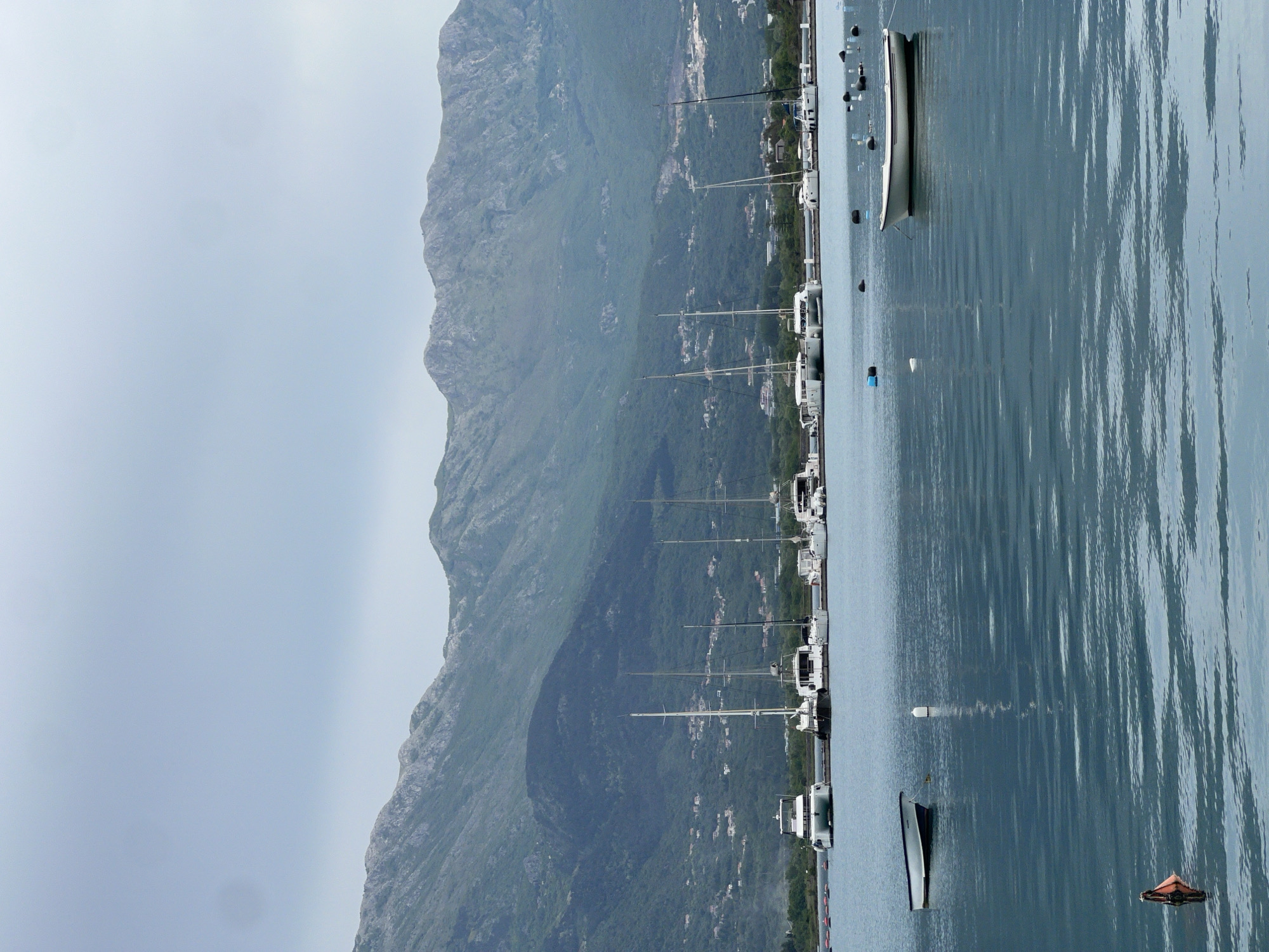 Boats moored in quiet Đuraševići harbor, Montenegro