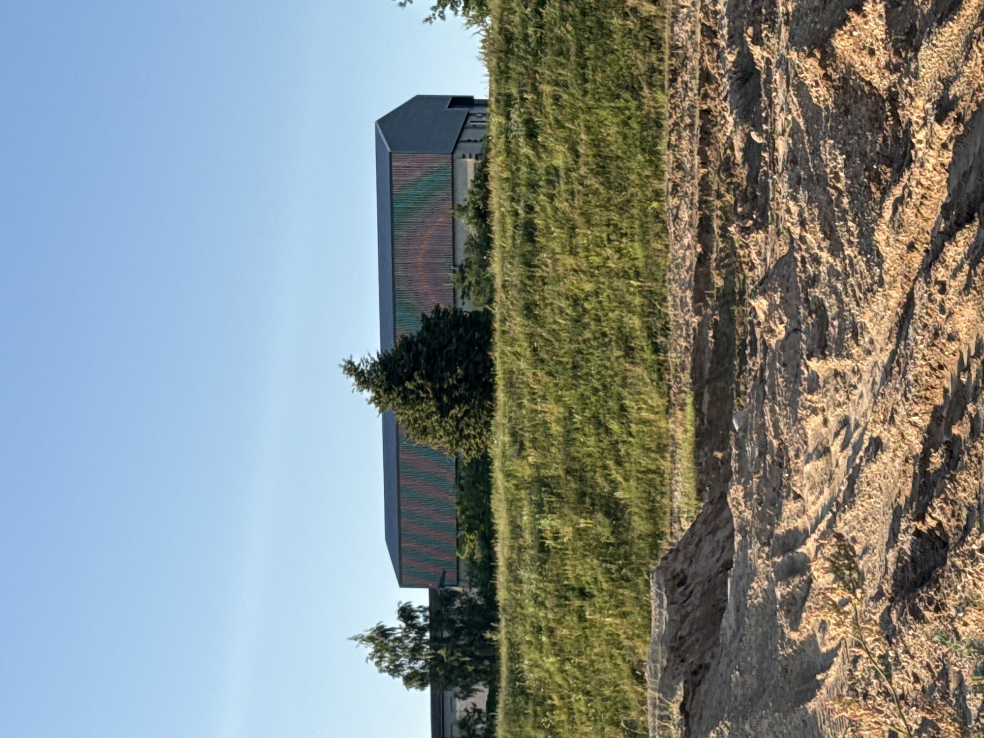 Countryside and horses near a modern building in rural Lithuania