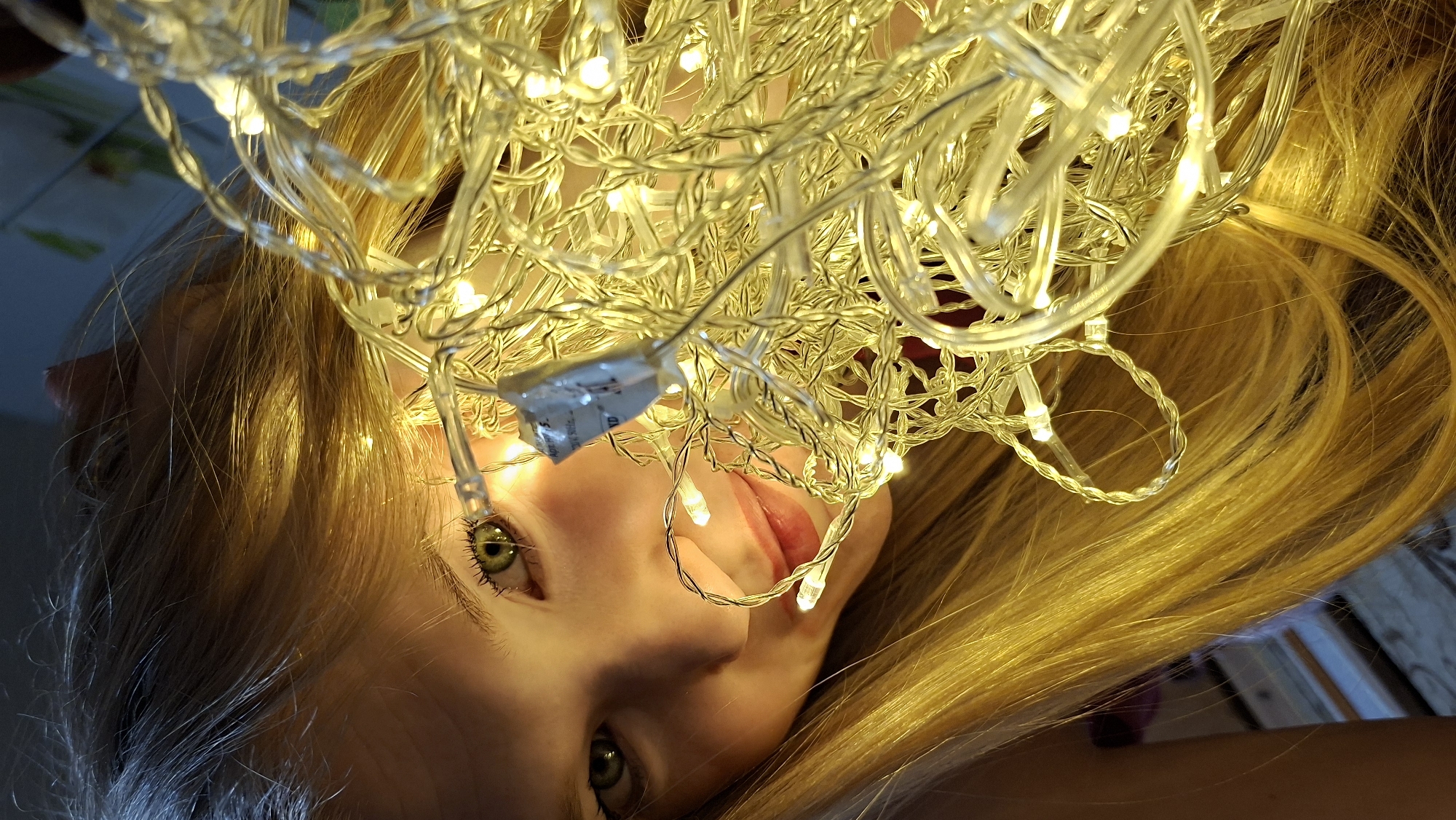 Young woman poses with fairy lights in Russian photoshoot