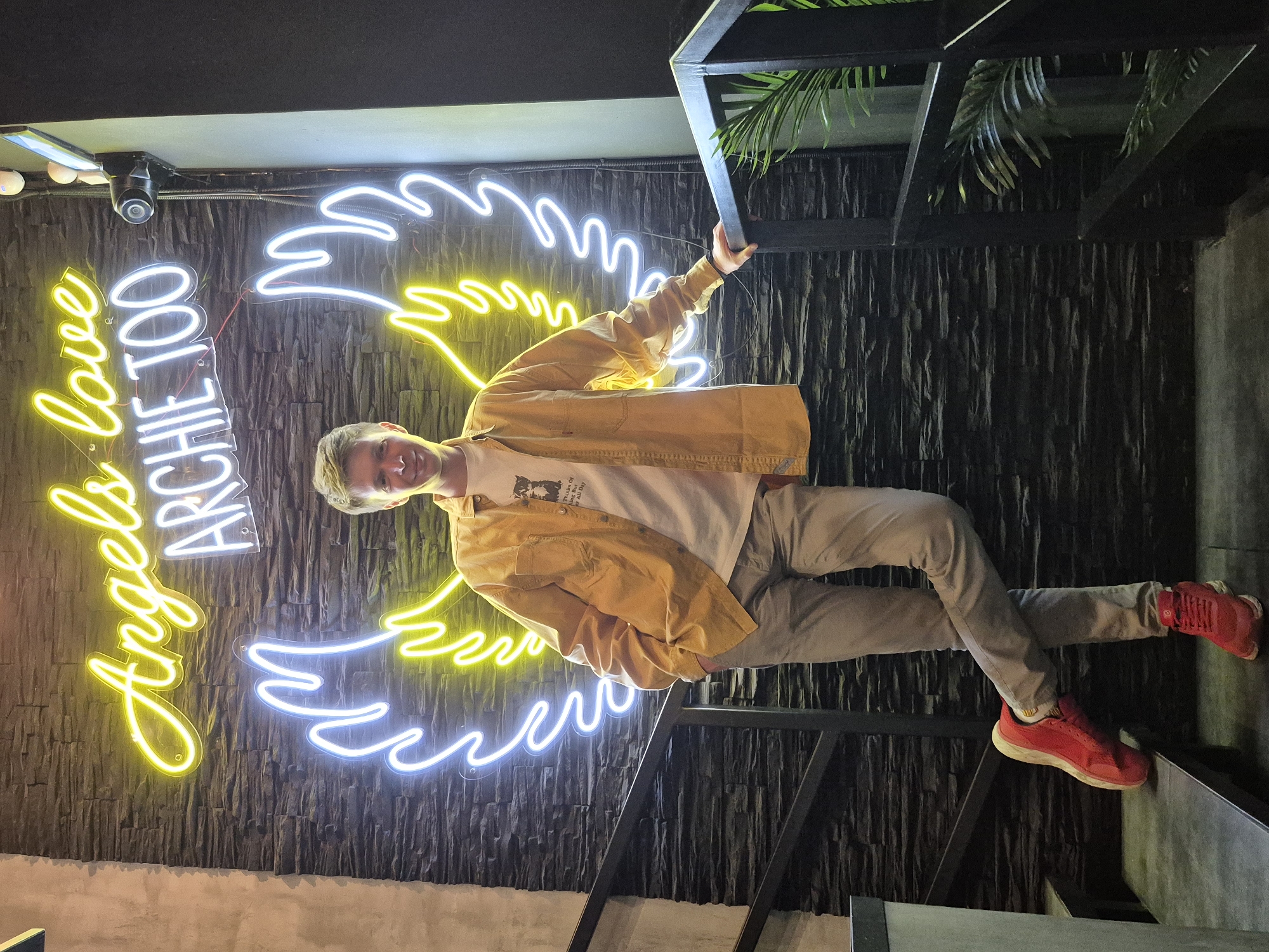 Social gathering at neon-lit venue in Izhevsk features angel-themed decor