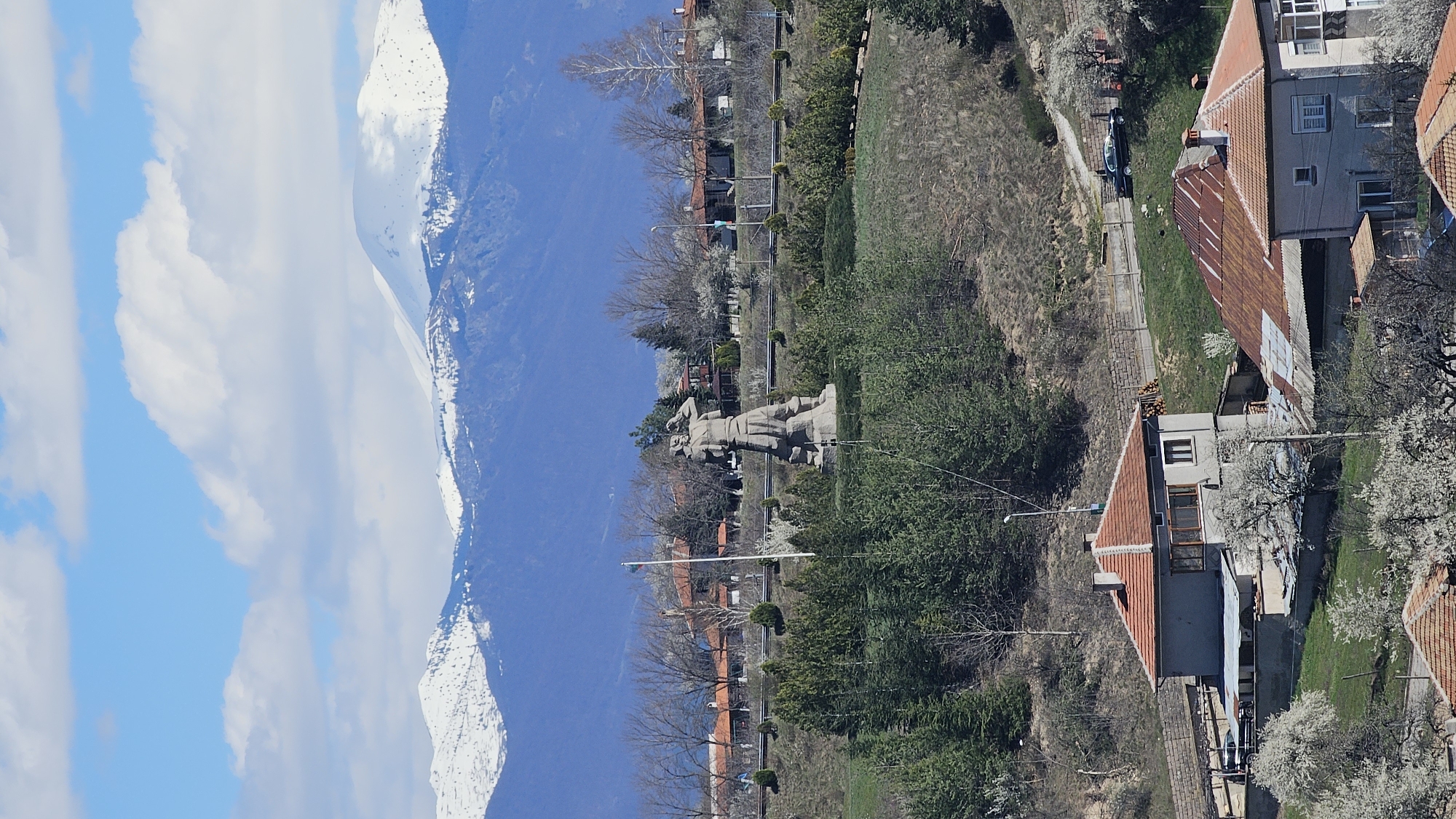 Witness documents mountain landscape with snow peaks, houses