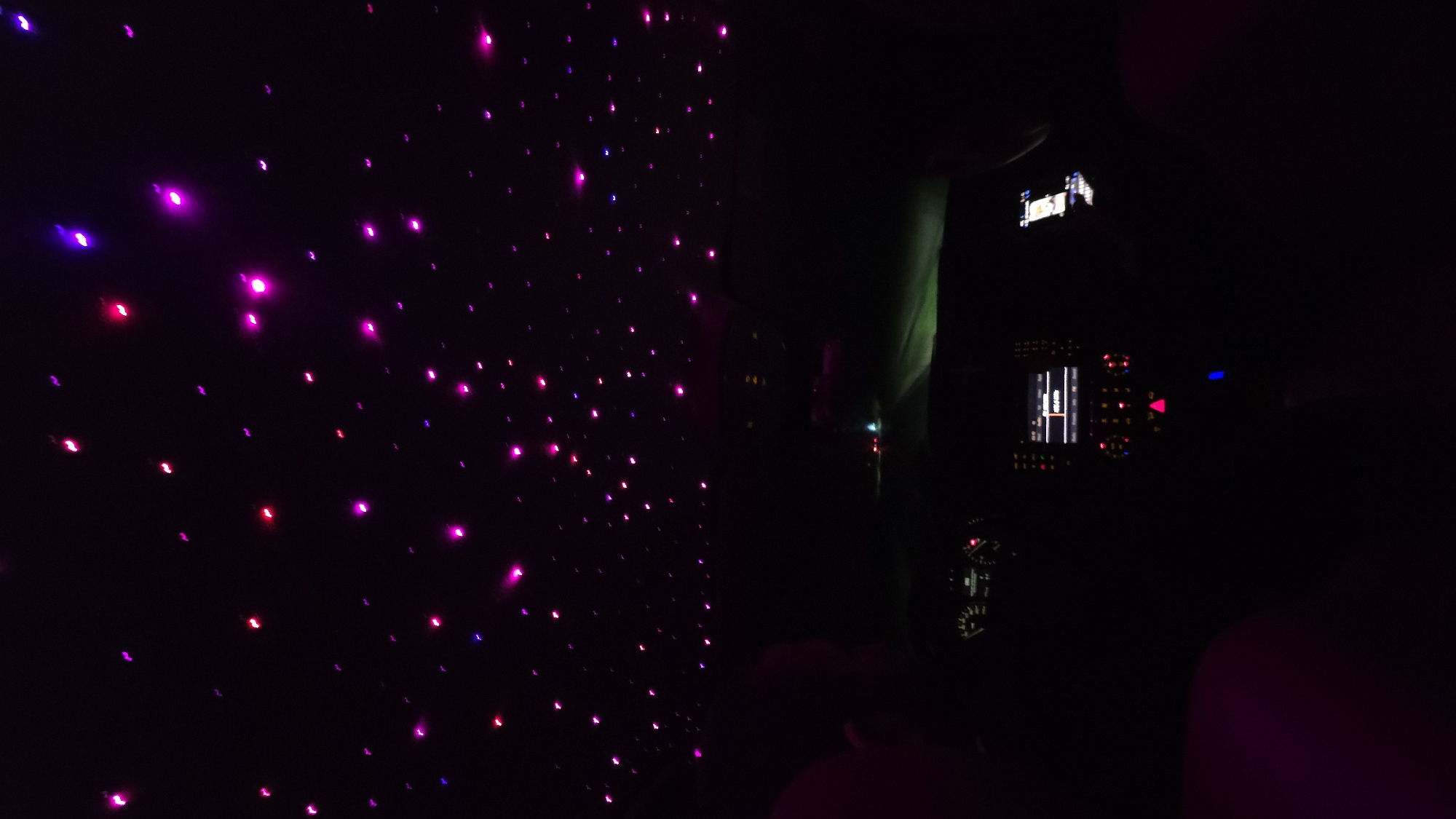 Dark vehicle interior with glowing decorations observed in Oreshak