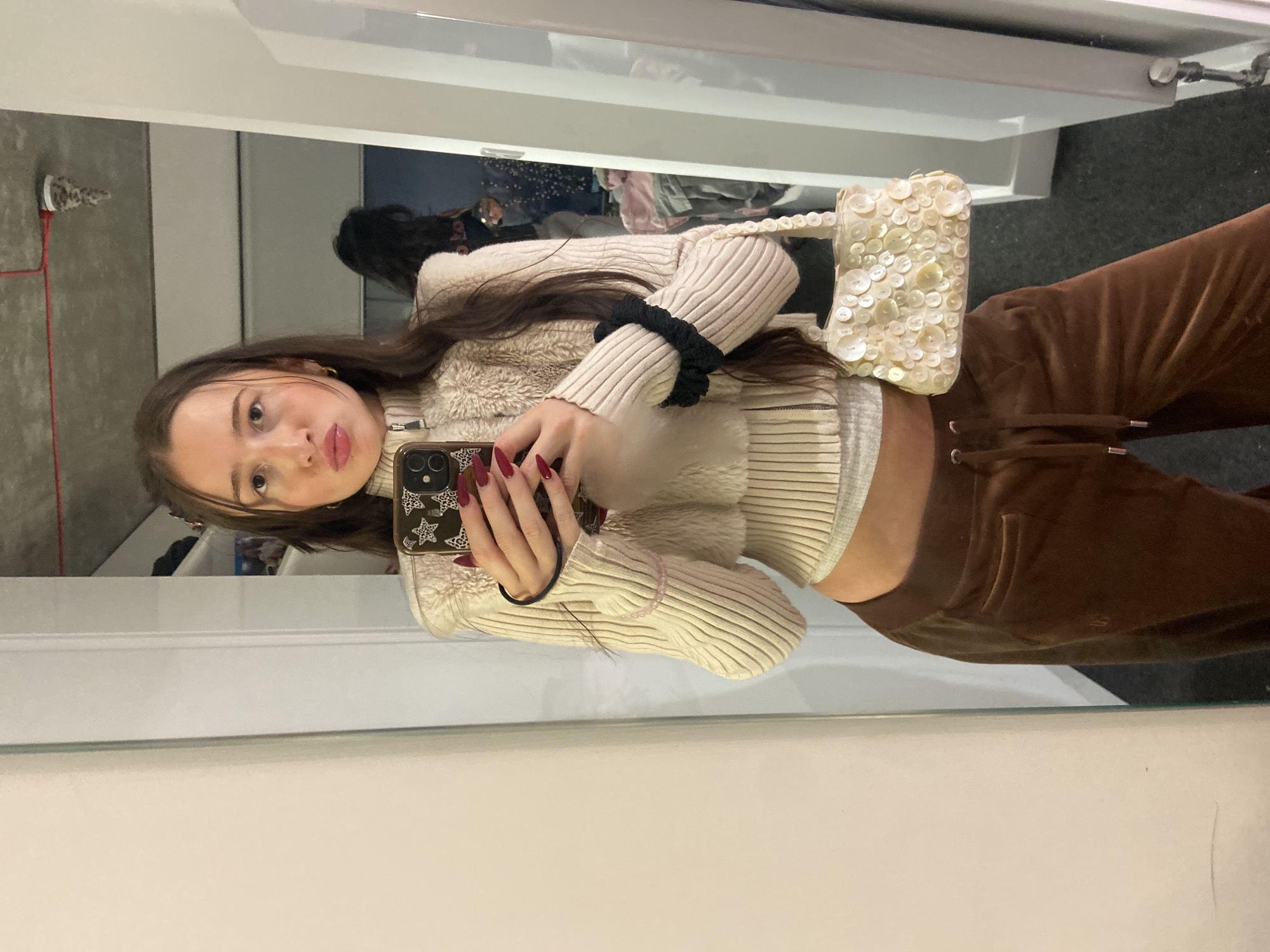 Young women take mirror selfies in London room