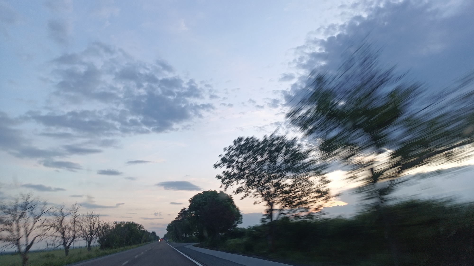 Evening drive through Chernograd shows cloudy sunset horizon