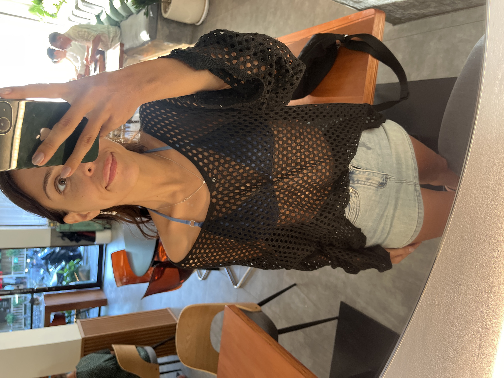 Woman takes mirror selfies at indoor venue in Kuta Selatan