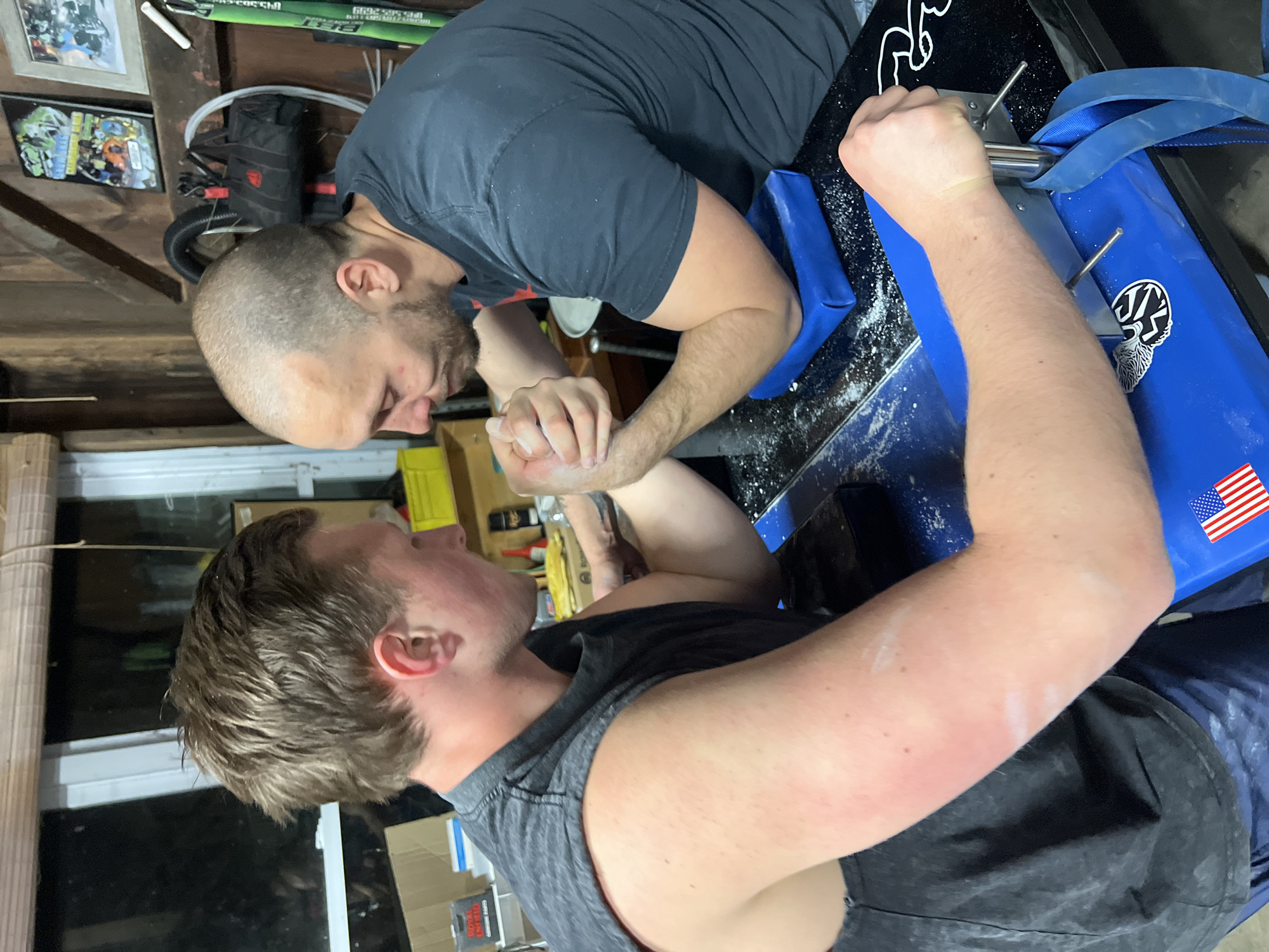 Late-night arm wrestling match captured in Orange Lake garage