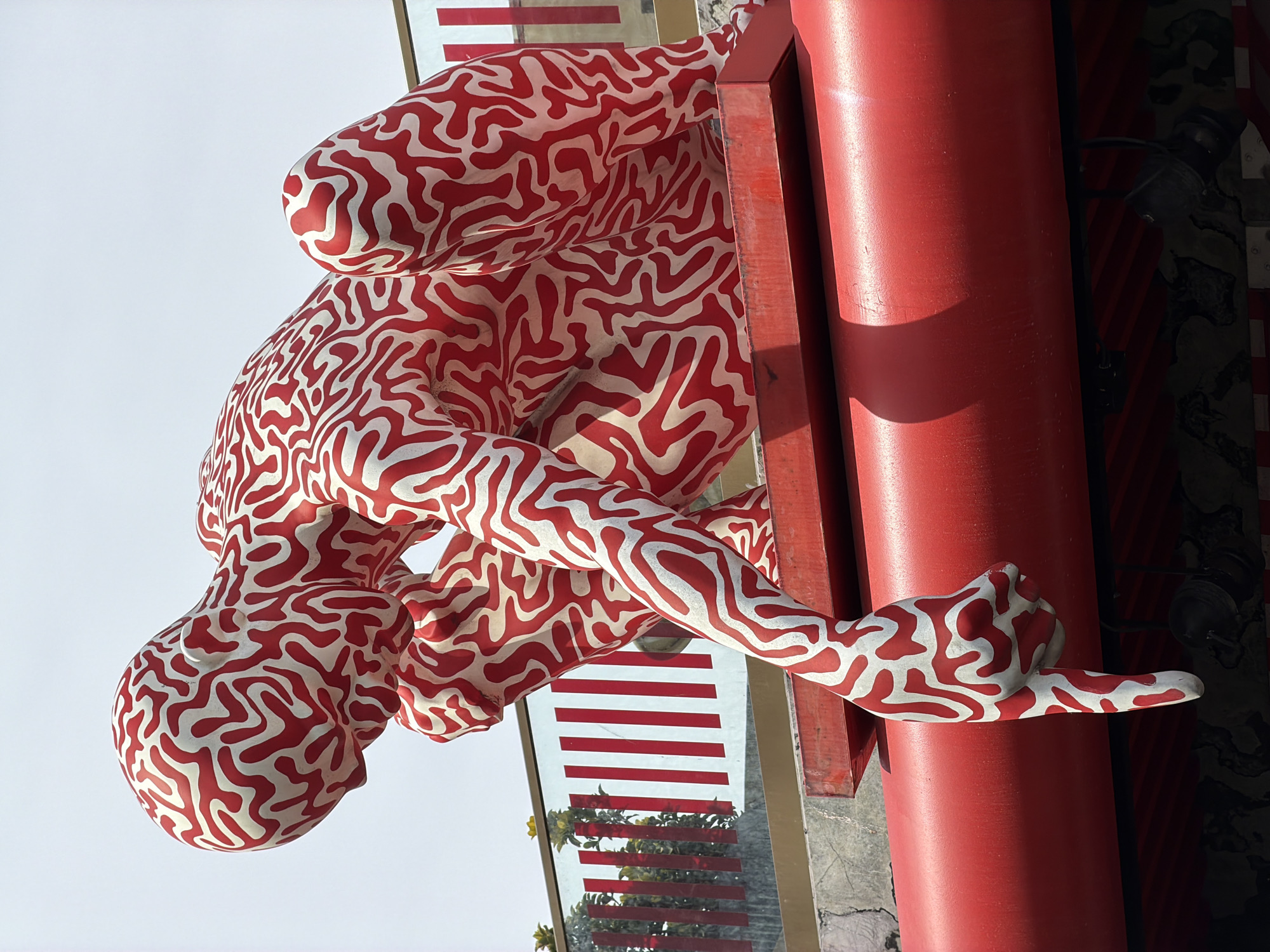 Maze-patterned human sculpture spotted near red column in Istanbul