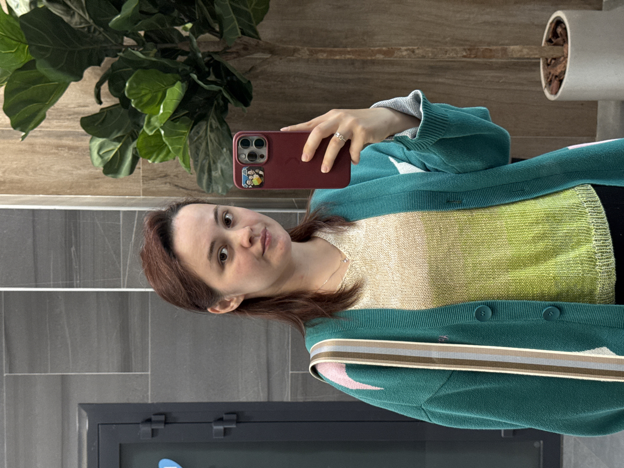 Mirror selfie showcasing a layered knit outfit in Izhevsk
