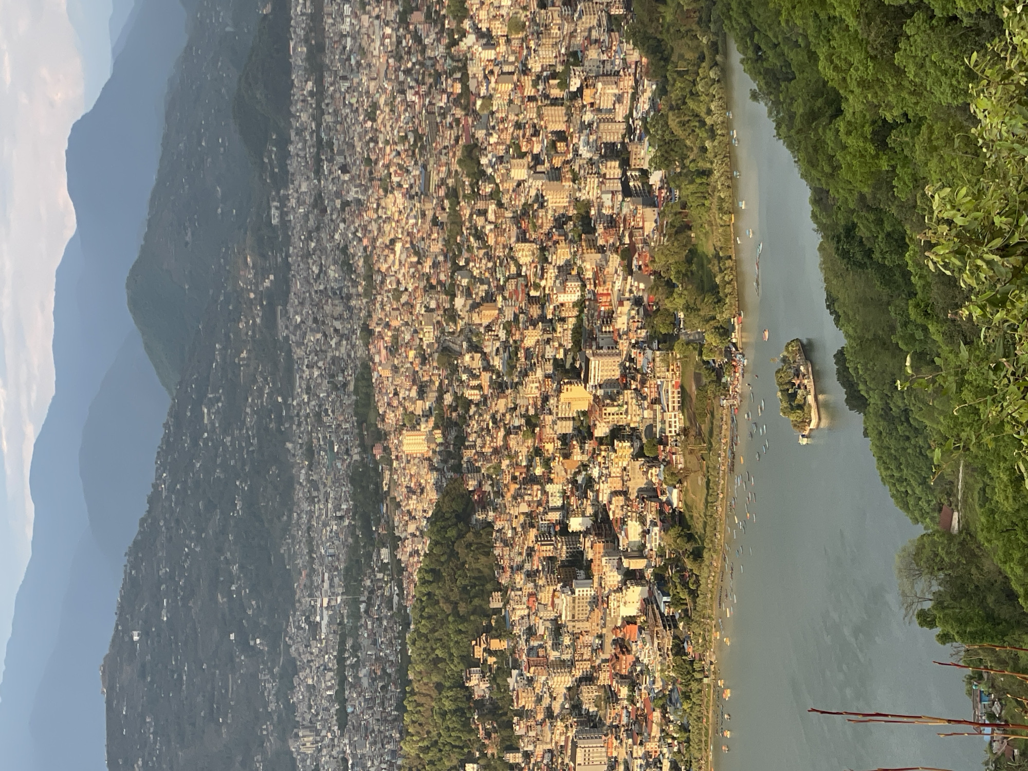Dense urban development observed in Pokhara between mountains, lake