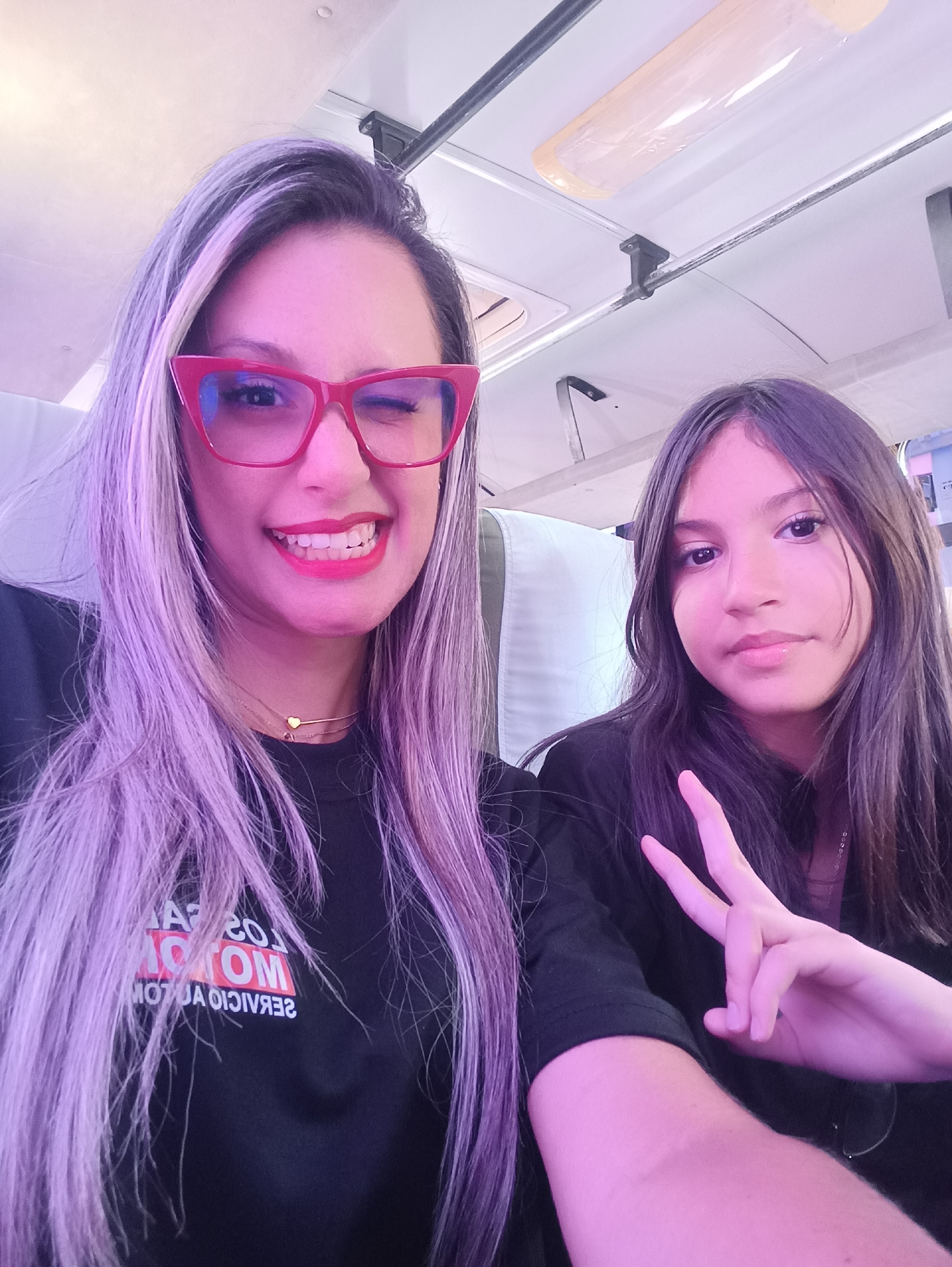 Adult and child take playful selfies in Las Tejerías