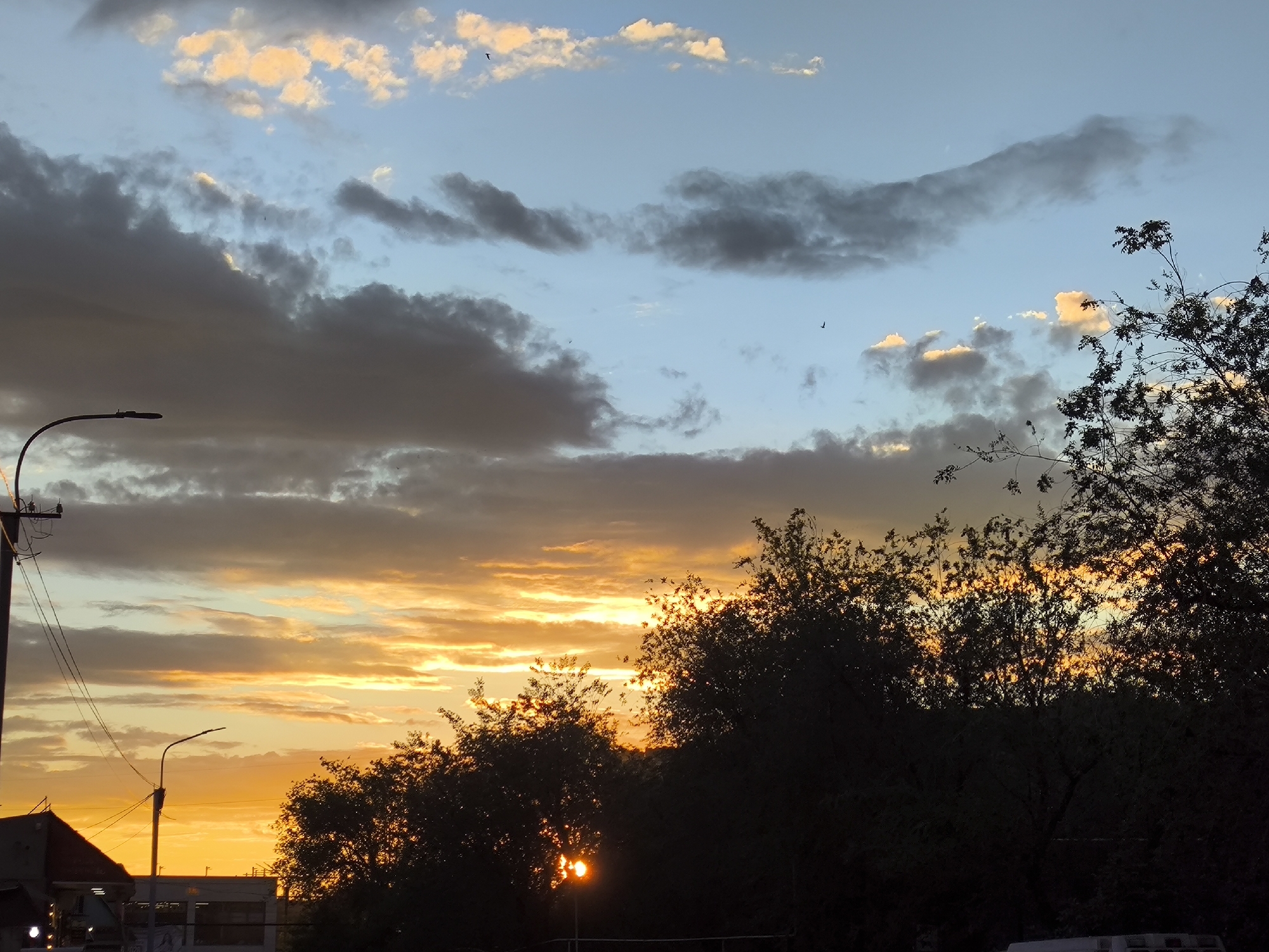 Yerevan sunset sky, clouds lit gold and pink at dusk