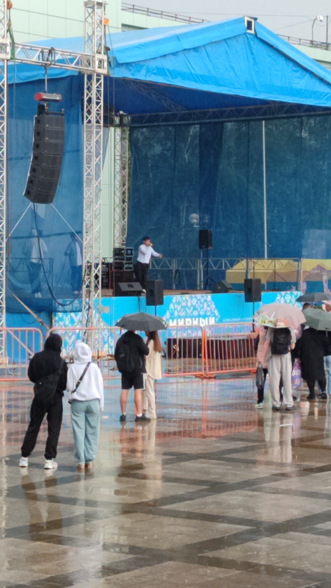 Rainy outdoor cultural performance at Mirny's ALROSA Palace of Culture