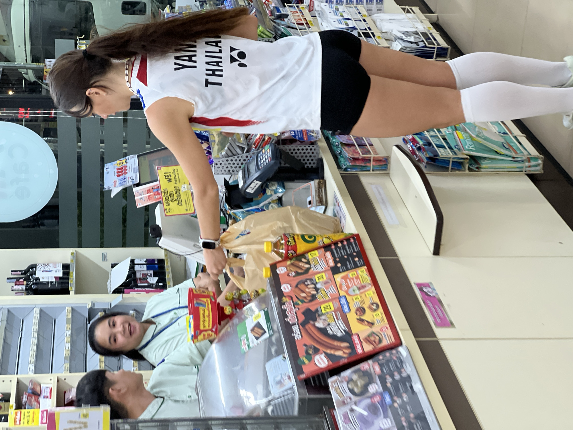 Woman in Thailand jersey shops at 7-Eleven in บ้านบางรักษ์