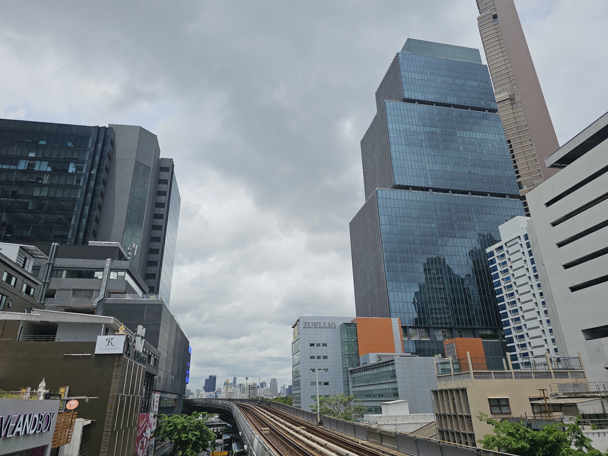 BTS platforms, mall eats, and Bangkok streets on a grey morning