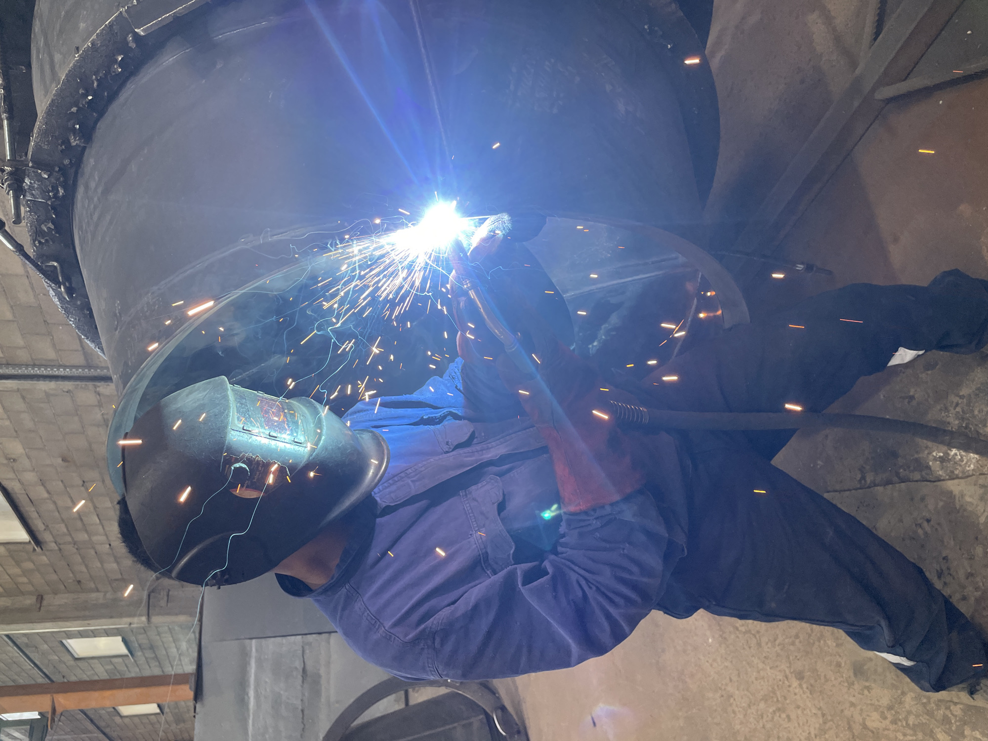 Metalworker fabricates cylindrical structure in Zaljevo workshop