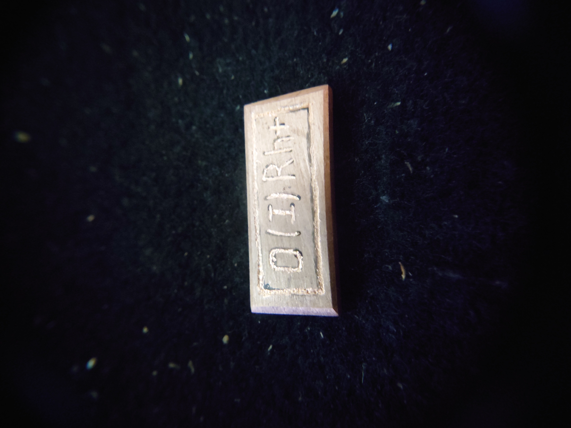 Close-up detail shots of engraved metal objects and backlit keyboards