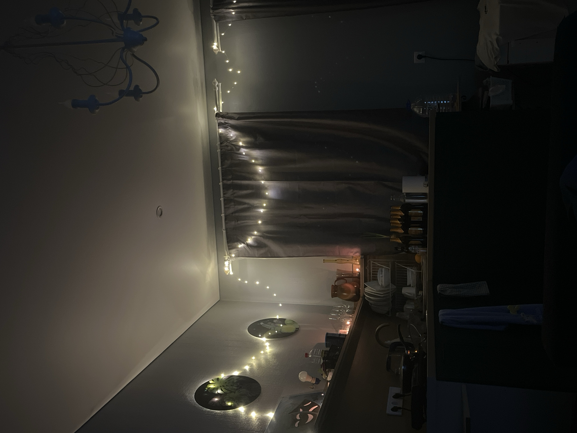 Interior space in Liepaja features blue chandelier, string lighting