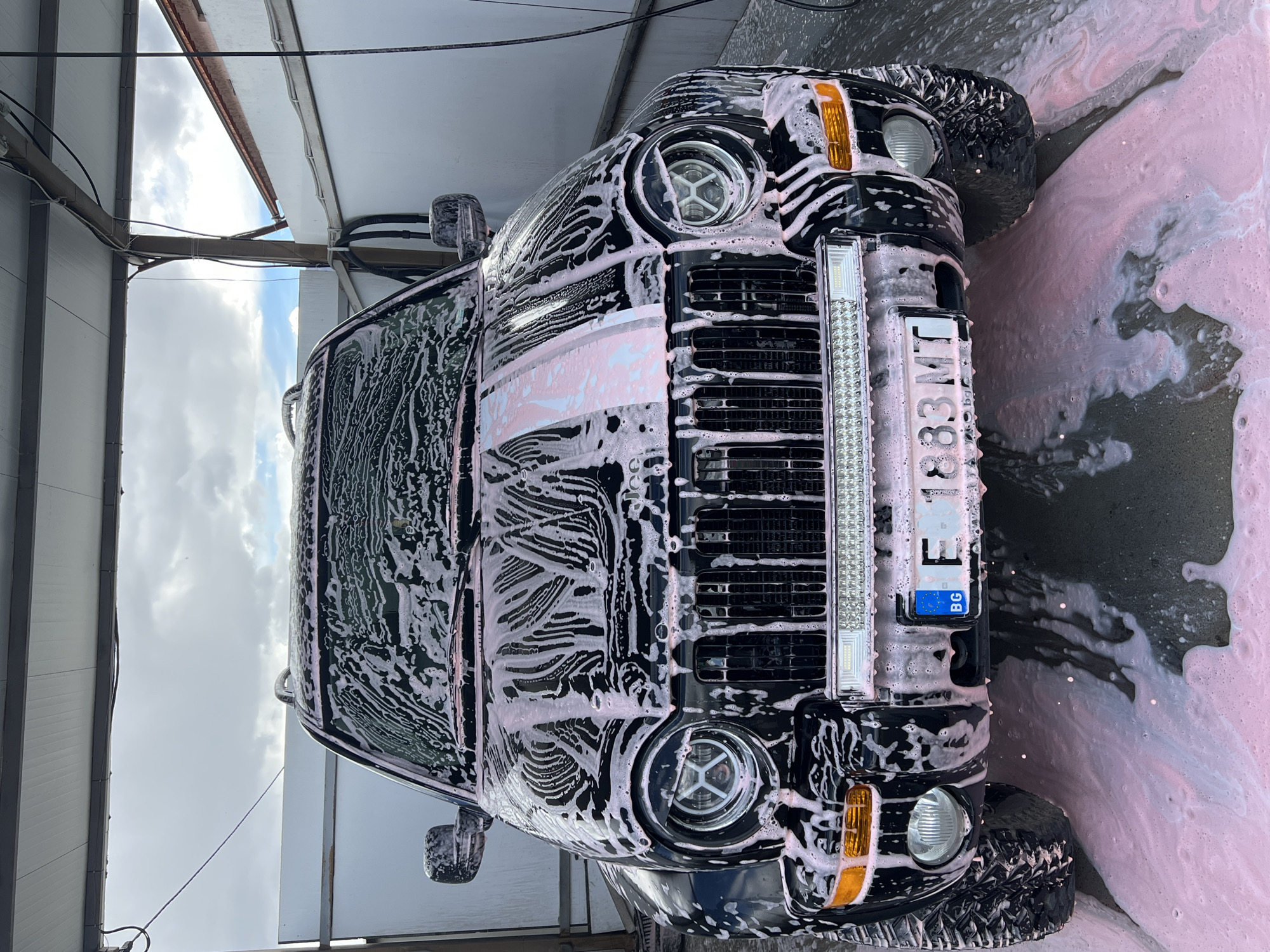Black SUV gets pink soap wash in Dabnitsa, Bulgaria