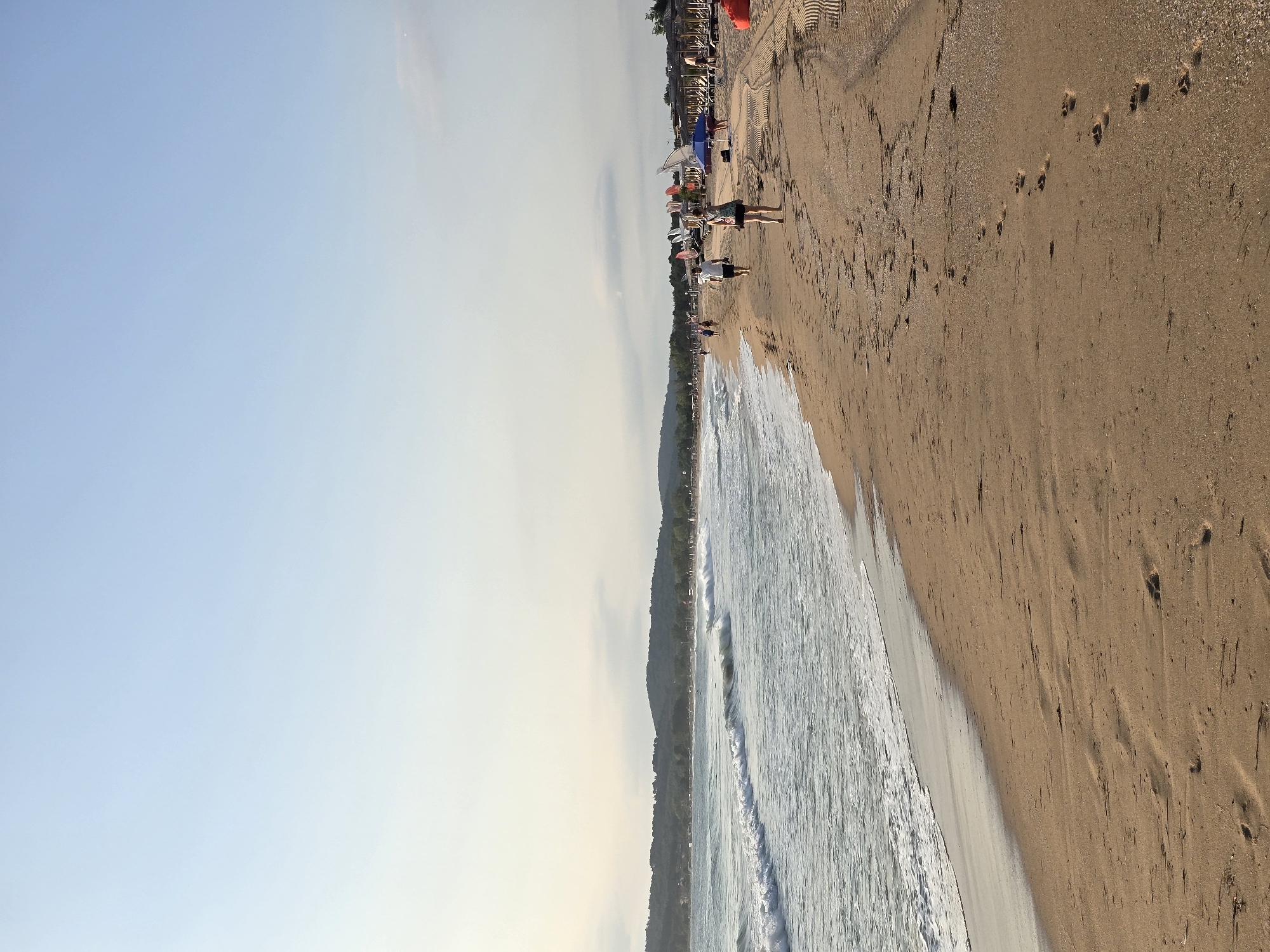 Quiet sandy shoreline in Sozopol with calm morning waves