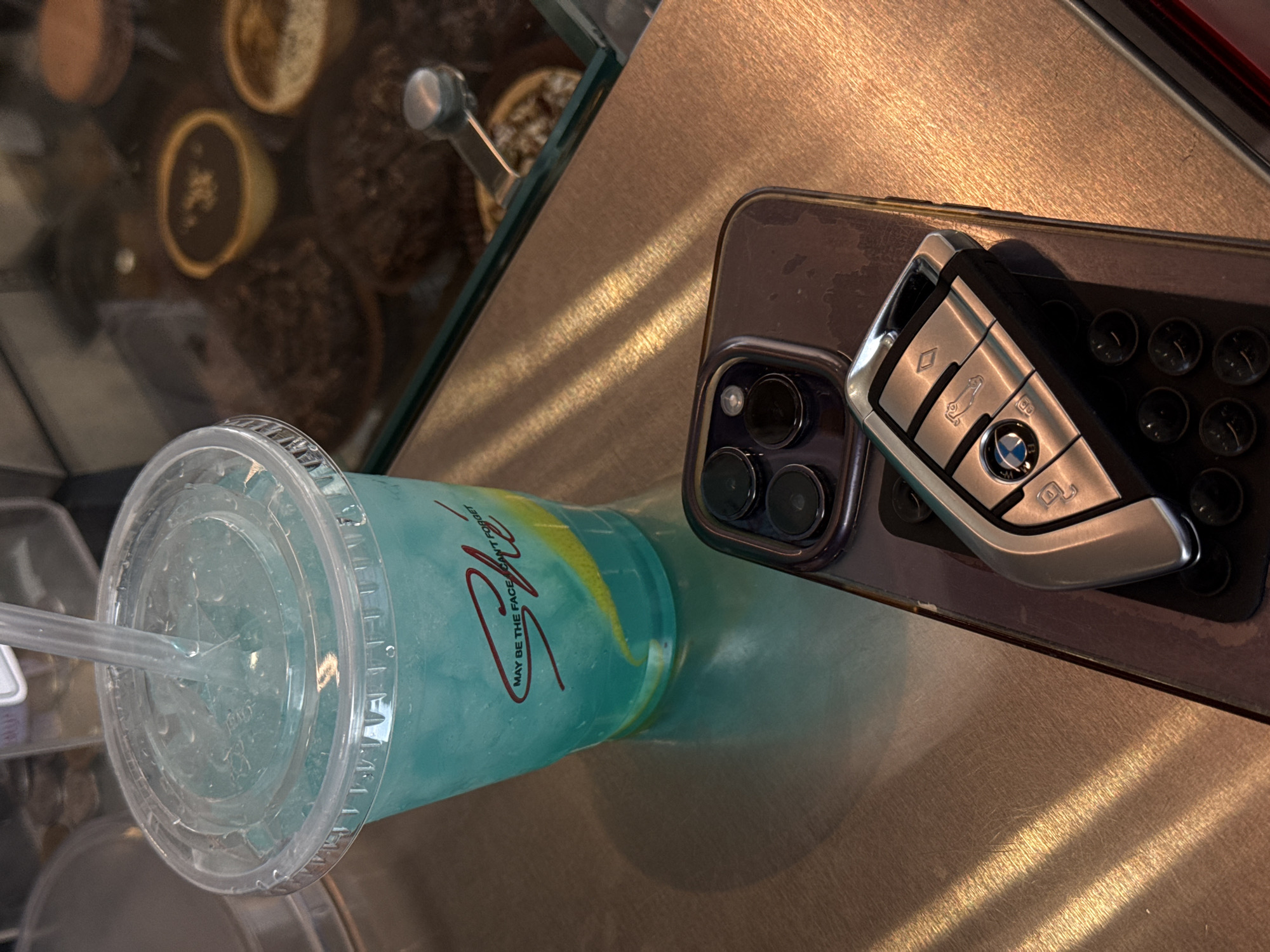 Branded blue drink photographed with phone, BMW key in Yerevan