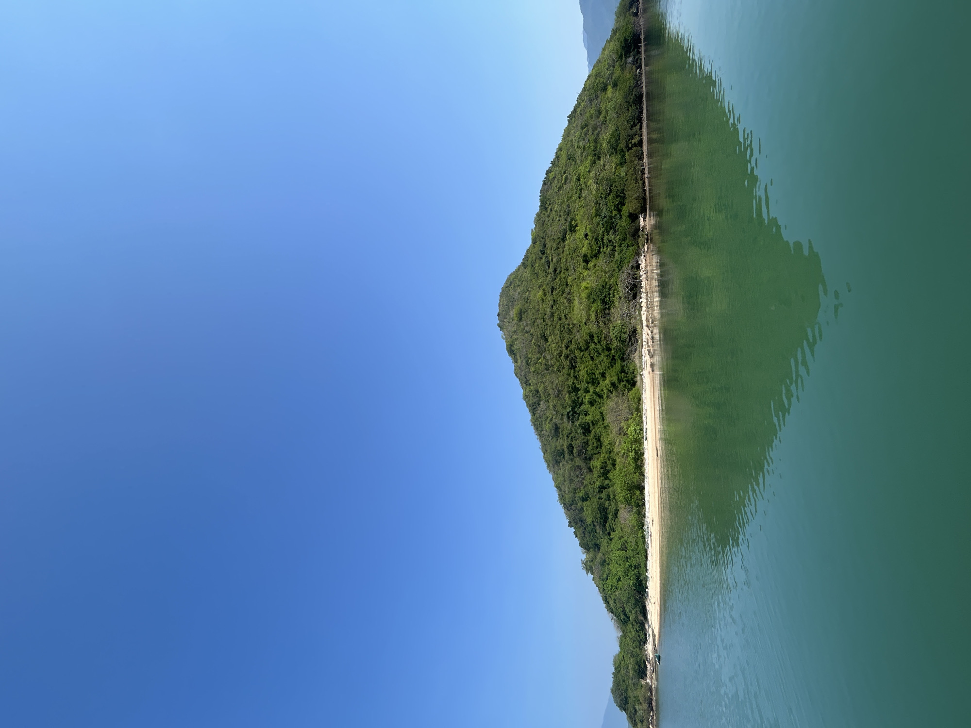 Calm turquoise bay and green island, Vĩnh Lương coast