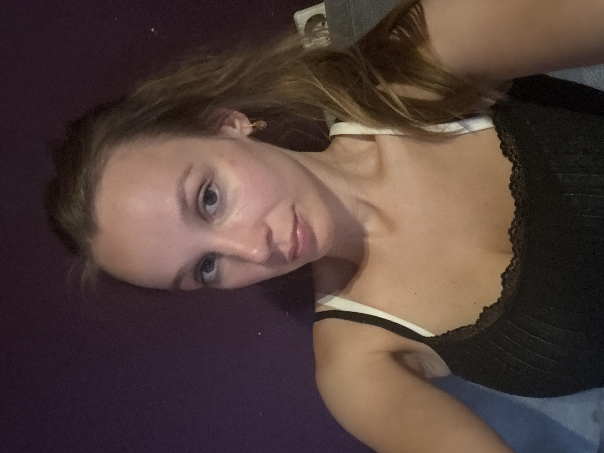 Casual selfie session on a gray couch in Überherrn