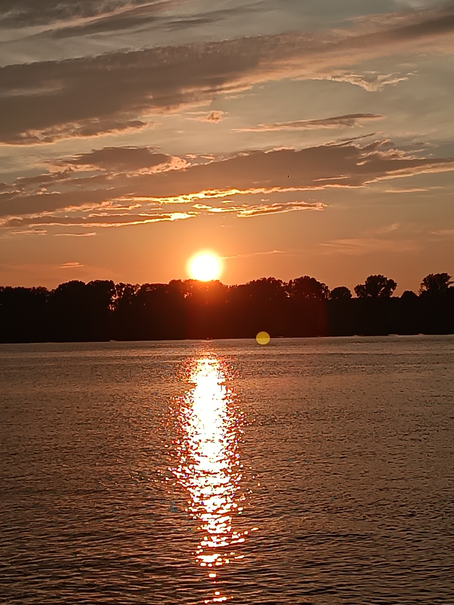 Sunset along the Kama River with ducks and rocky shoreline