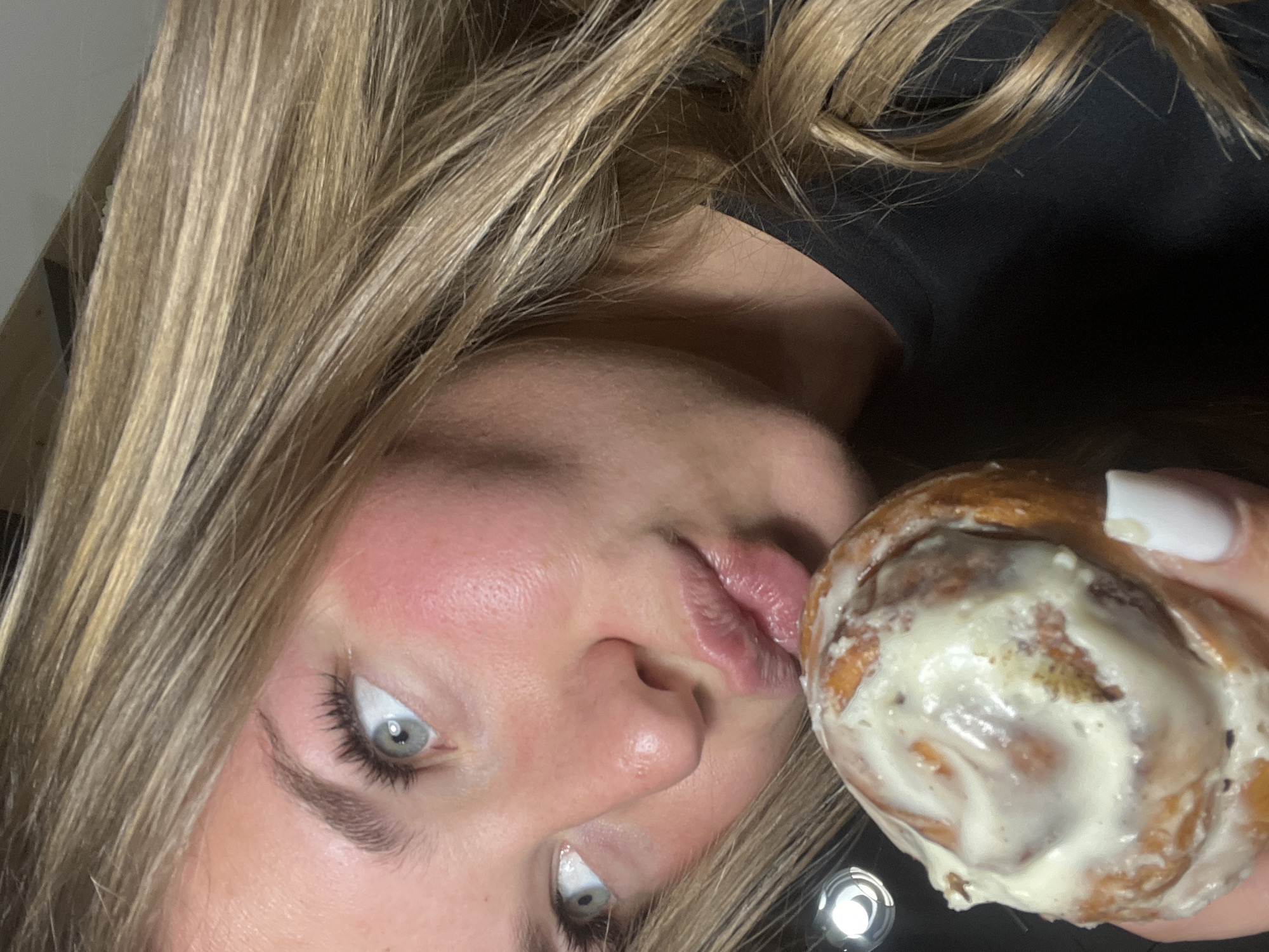 Woman enjoys glazed pastries in Budva selfie session