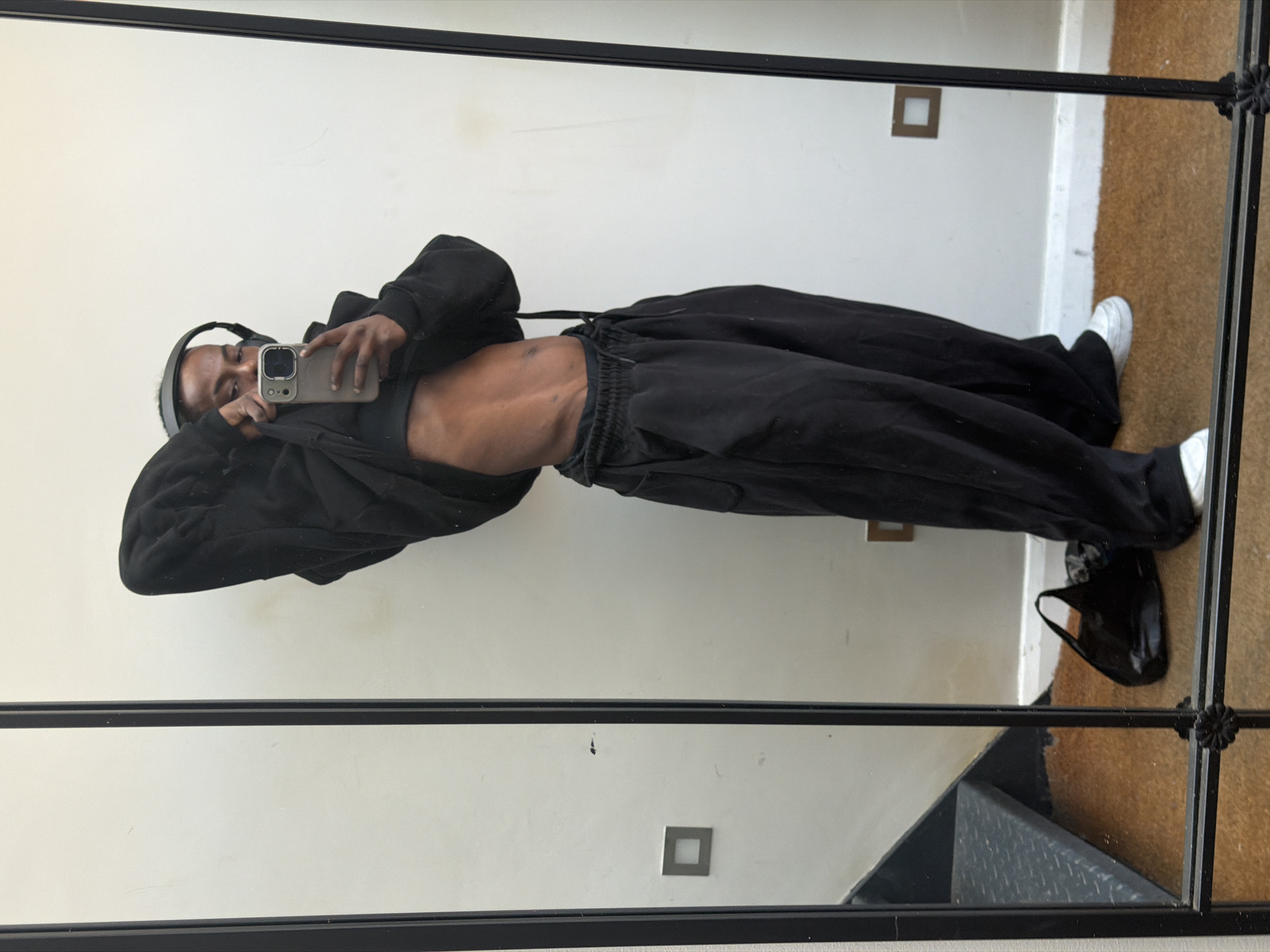 Person takes mirror selfie in London indoor location