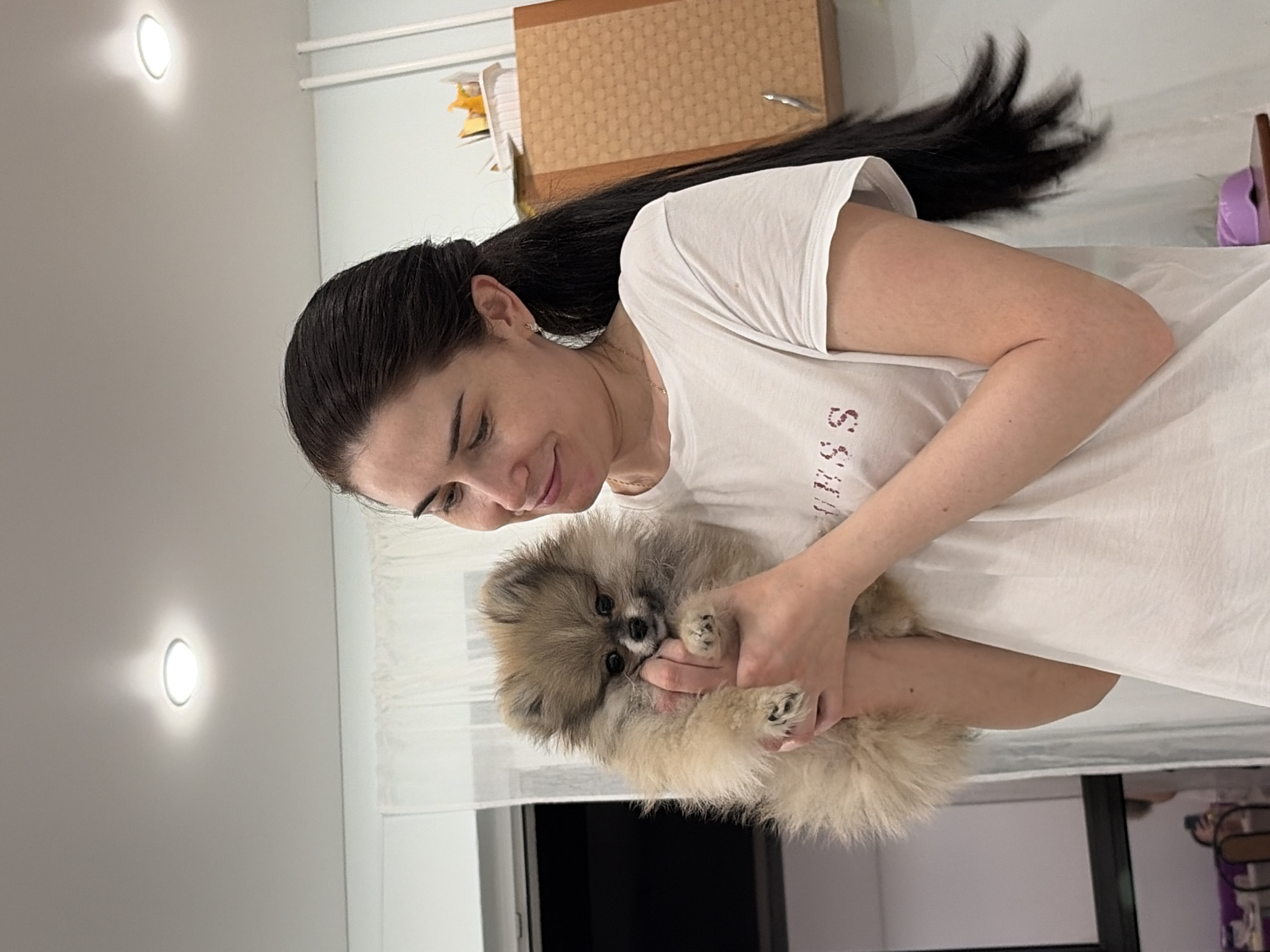 Woman cooks dinner with pet dog in Sertolovo home