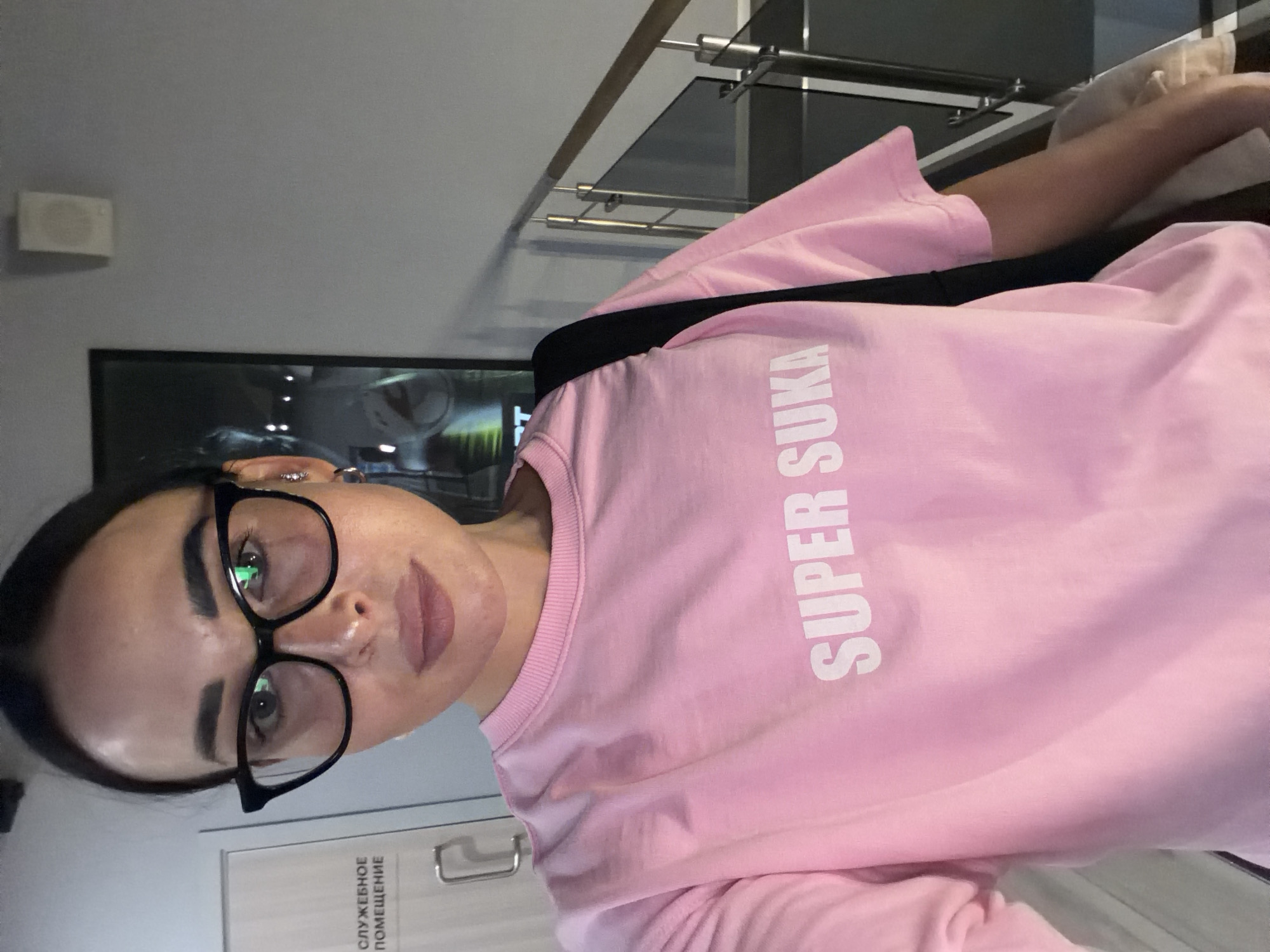 Hallway selfie in Saint Petersburg, pink tee, orange phone