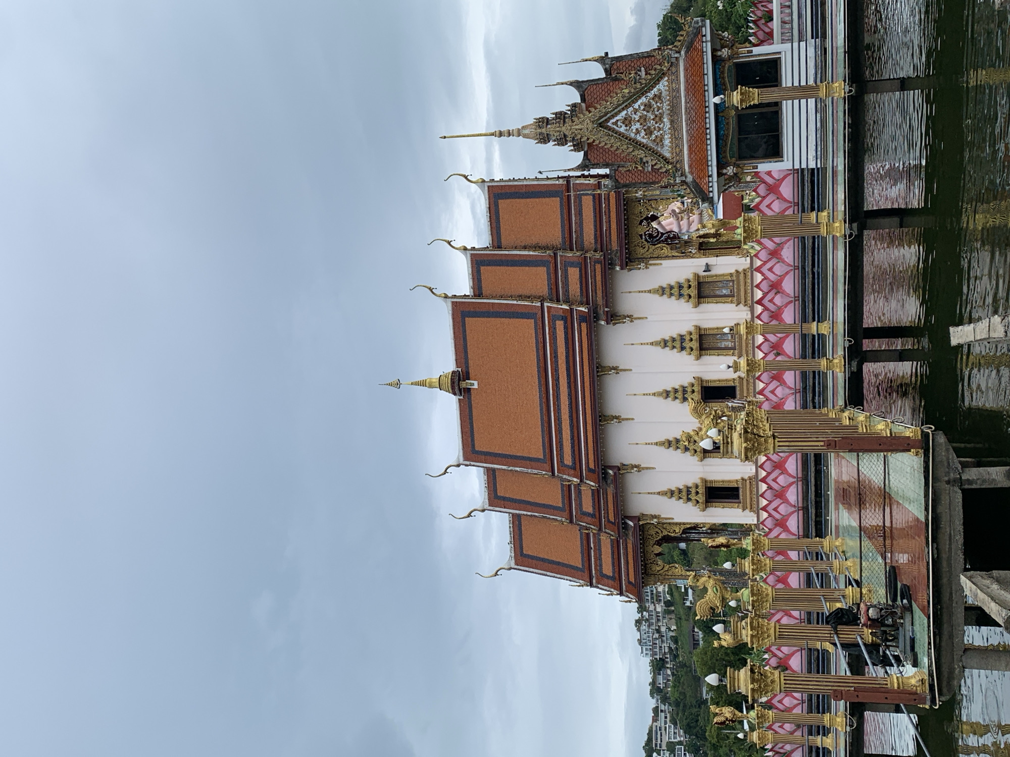 Tourist captures Thai temple complex with Buddhist statues, architecture