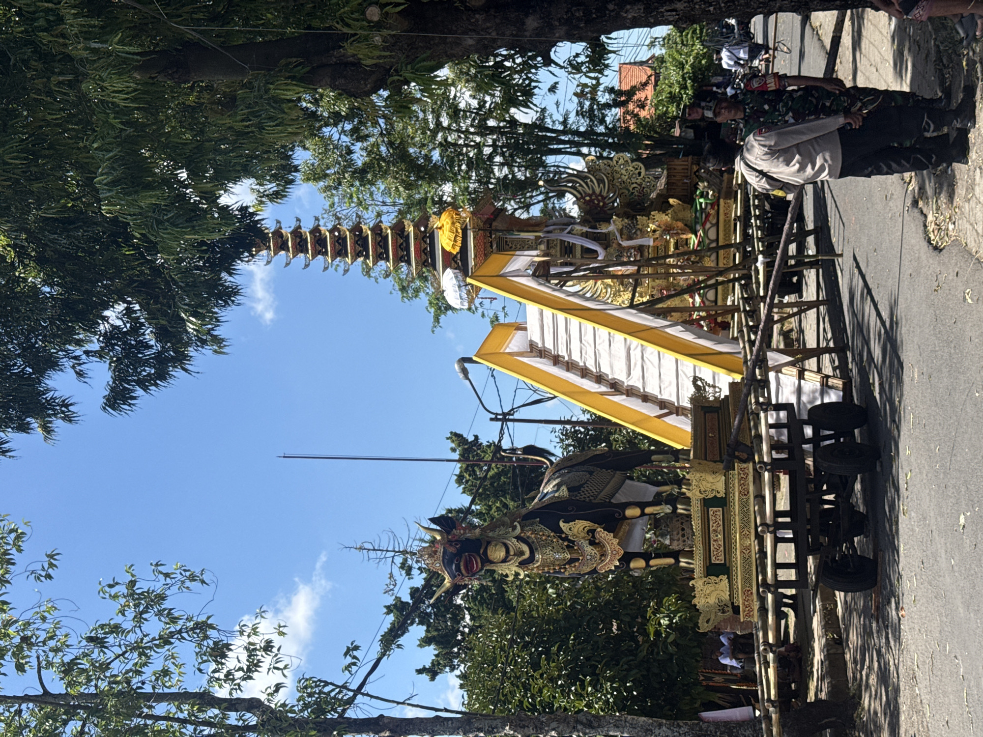 Religious procession with ceremonial floats observed in Pejeng, Indonesia