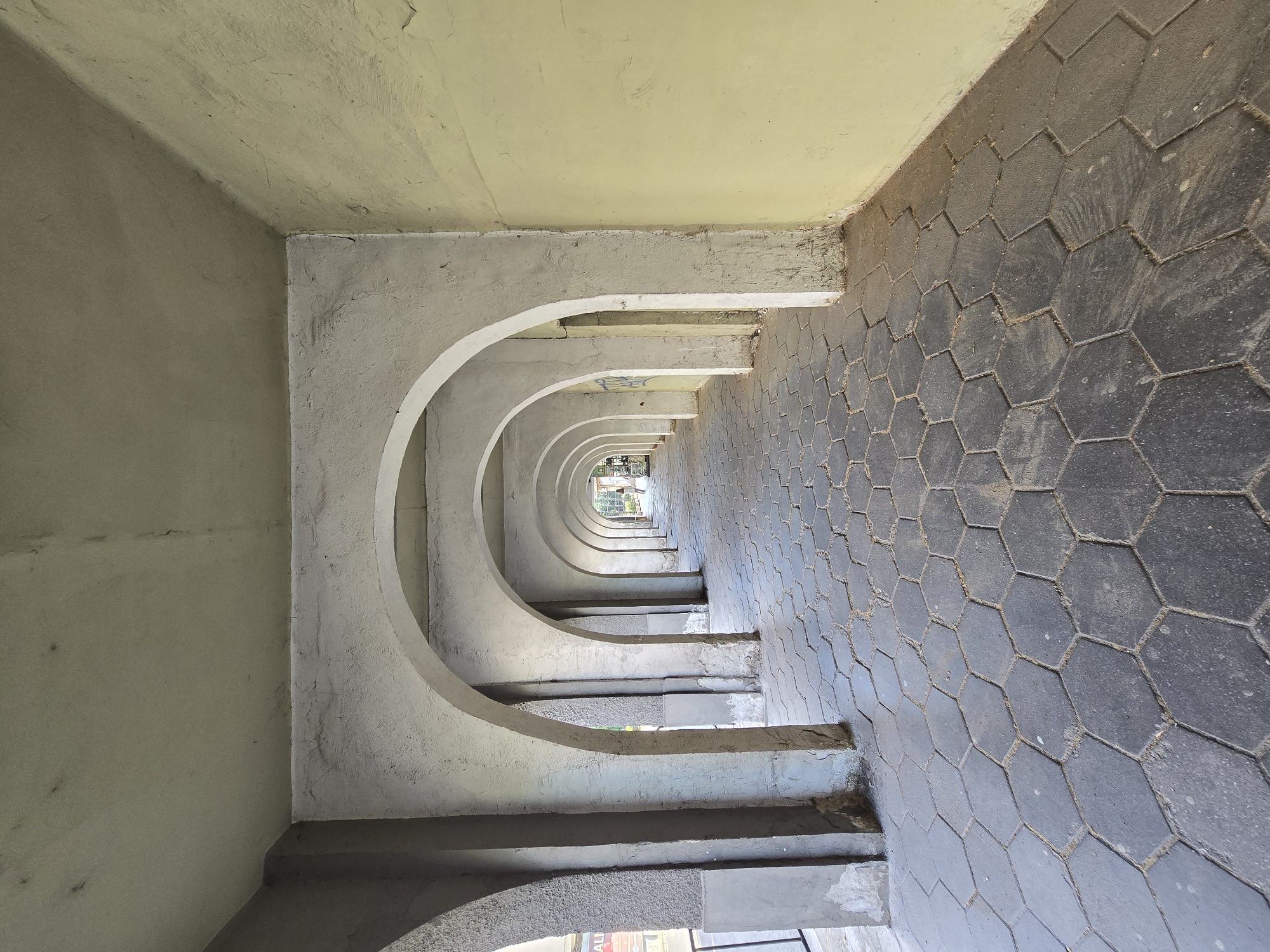 Architectural walkway with arches documented in unidentified urban location