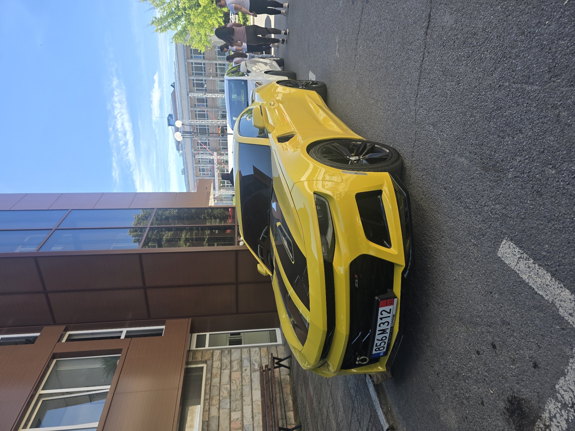Yellow Camaro ZL1 parked outside modern building in Berkovitsa