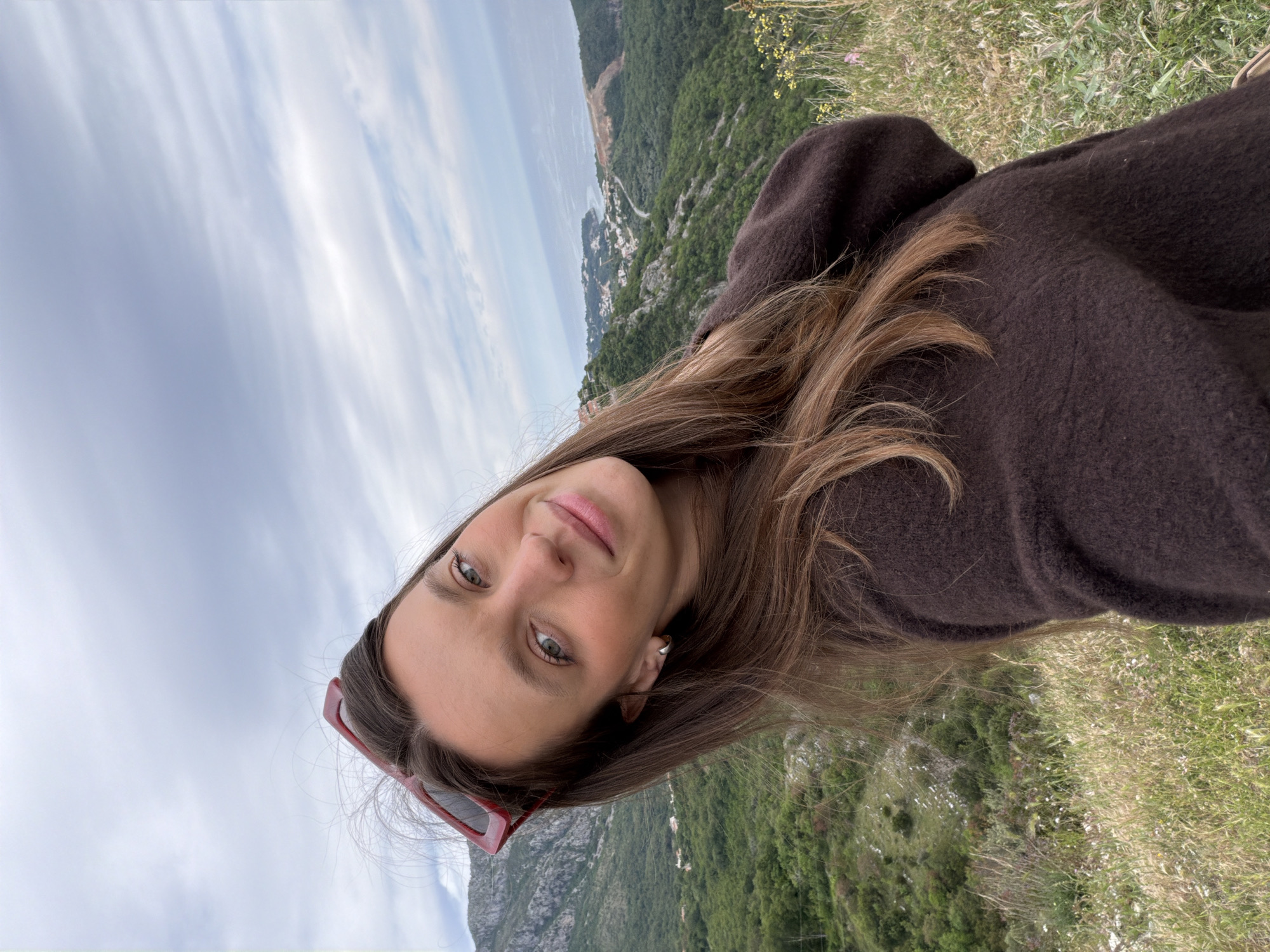Tourist captures selfie at Montenegro's scenic Sveti Stefan overlook