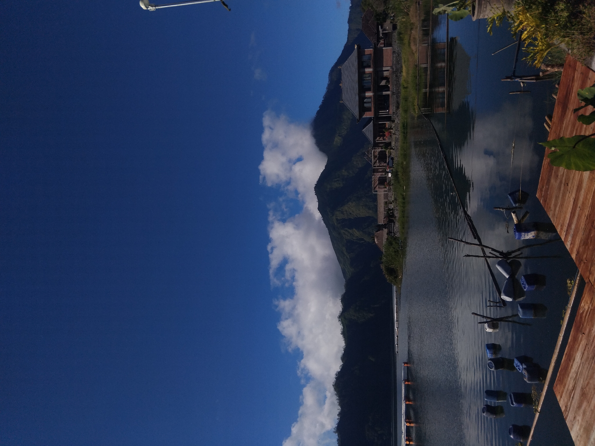Witness documents lakeside mountain landscape with modern buildings