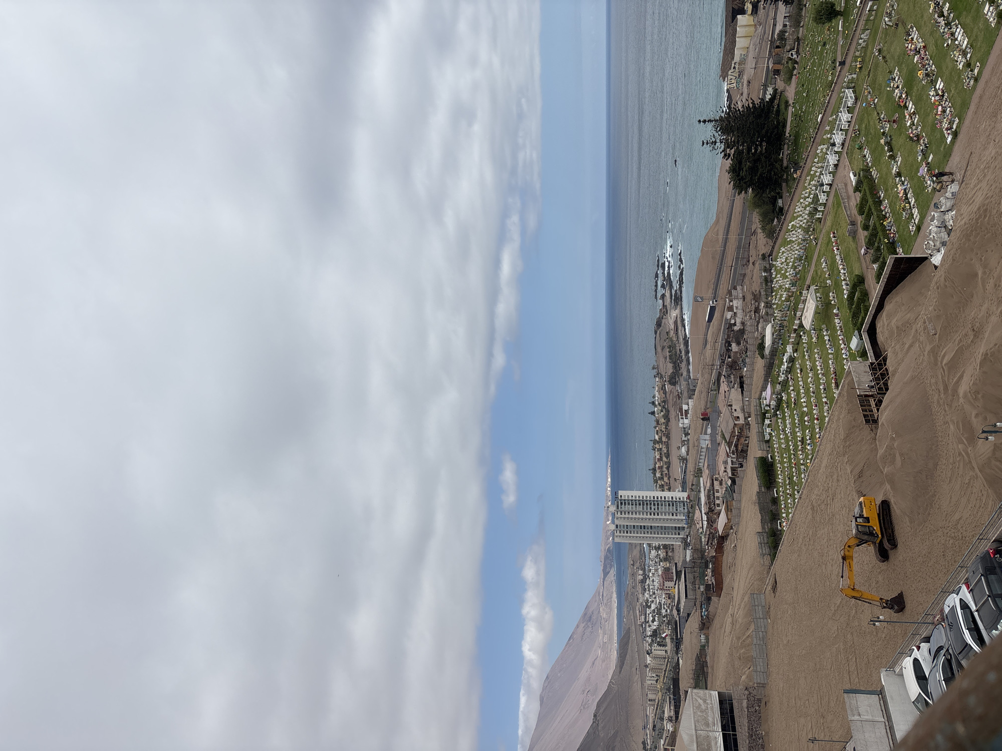 Iquique's flower-dotted cemetery seen from above, coast beyond