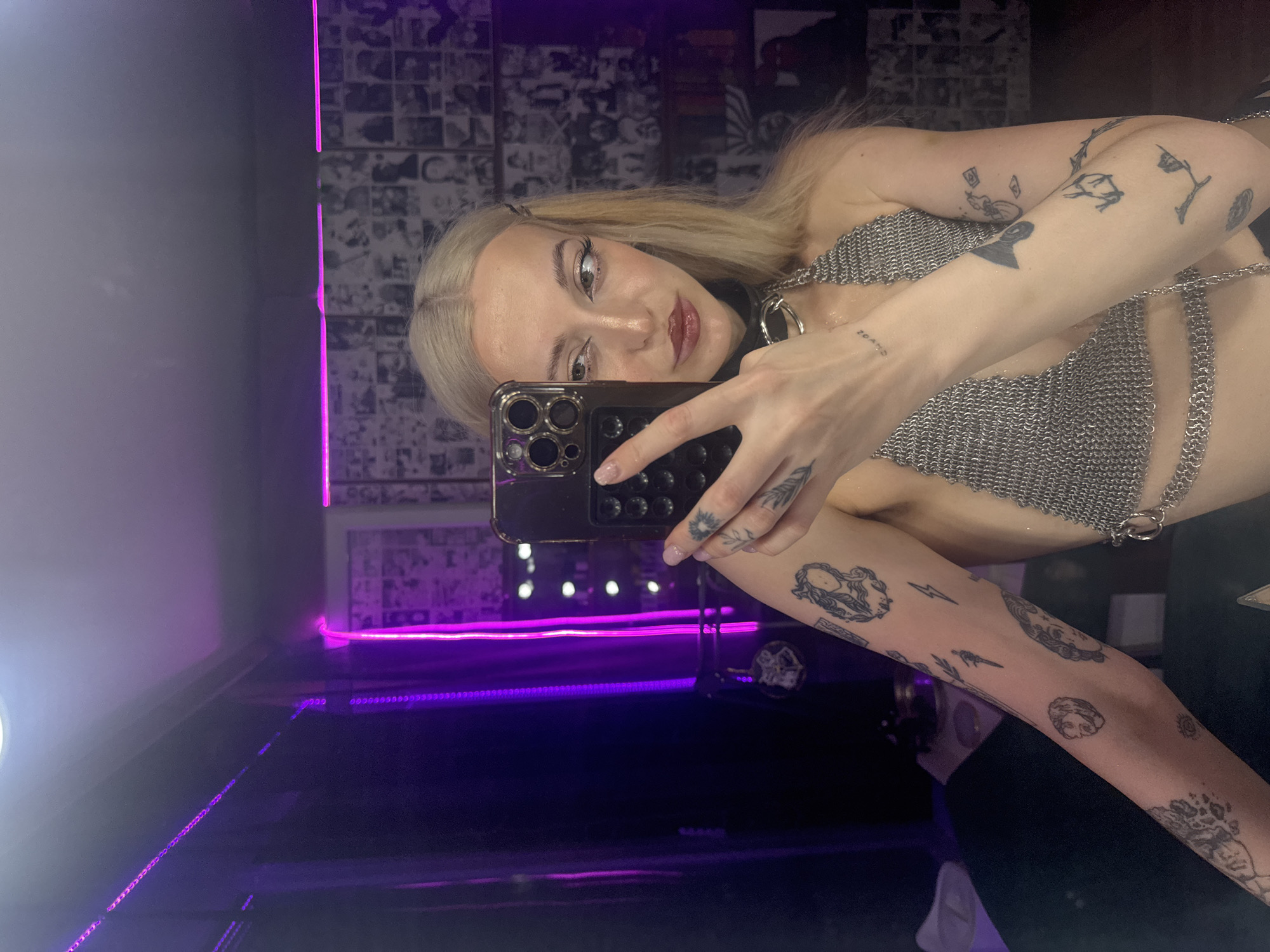 Woman takes selfies in neon-lit Moscow venue