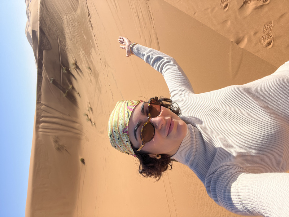 Woman photographs desert journey across Moroccan sand dunes near Rissani