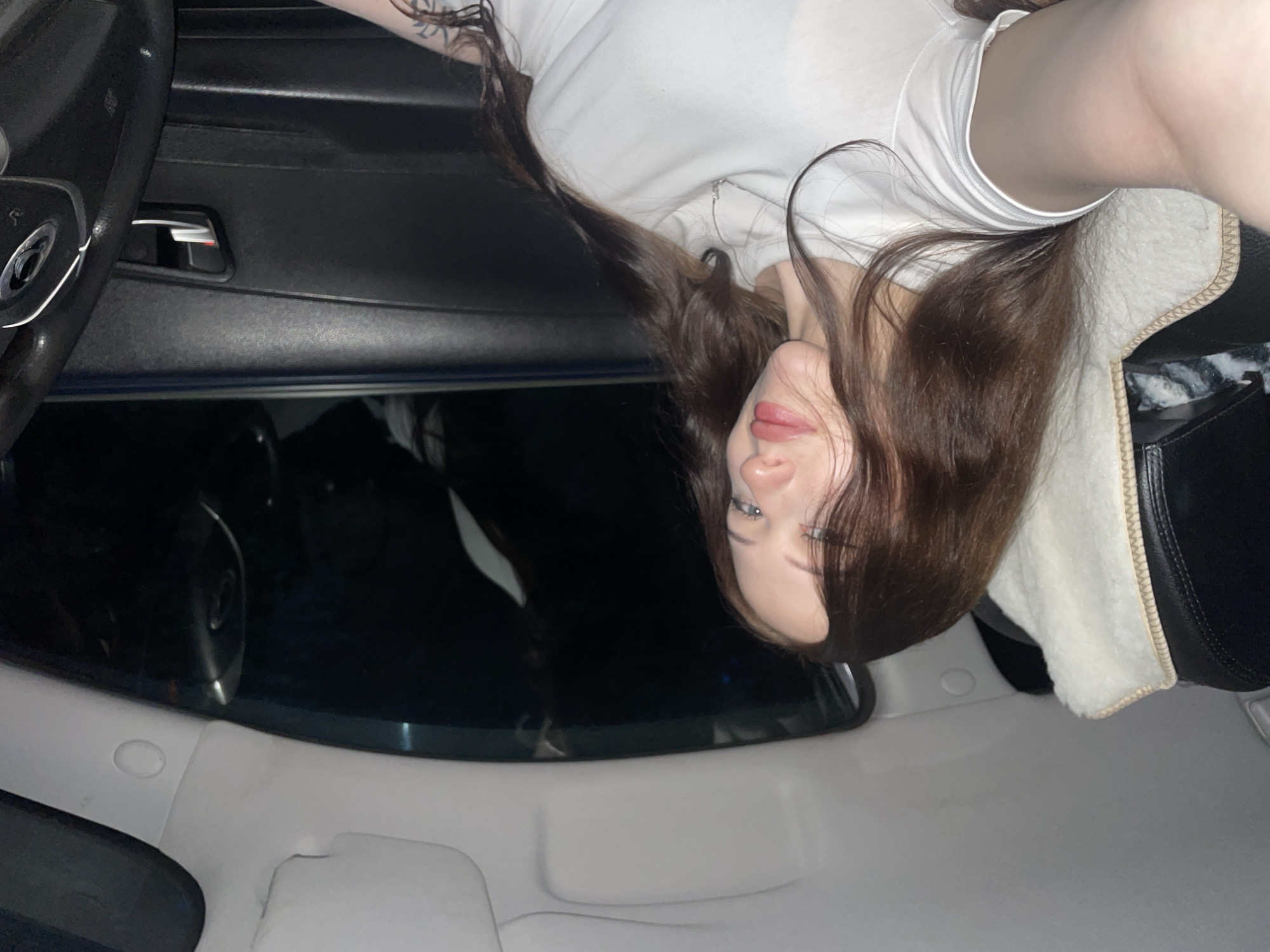 Woman photographed in car interior during evening in Gavrilovka