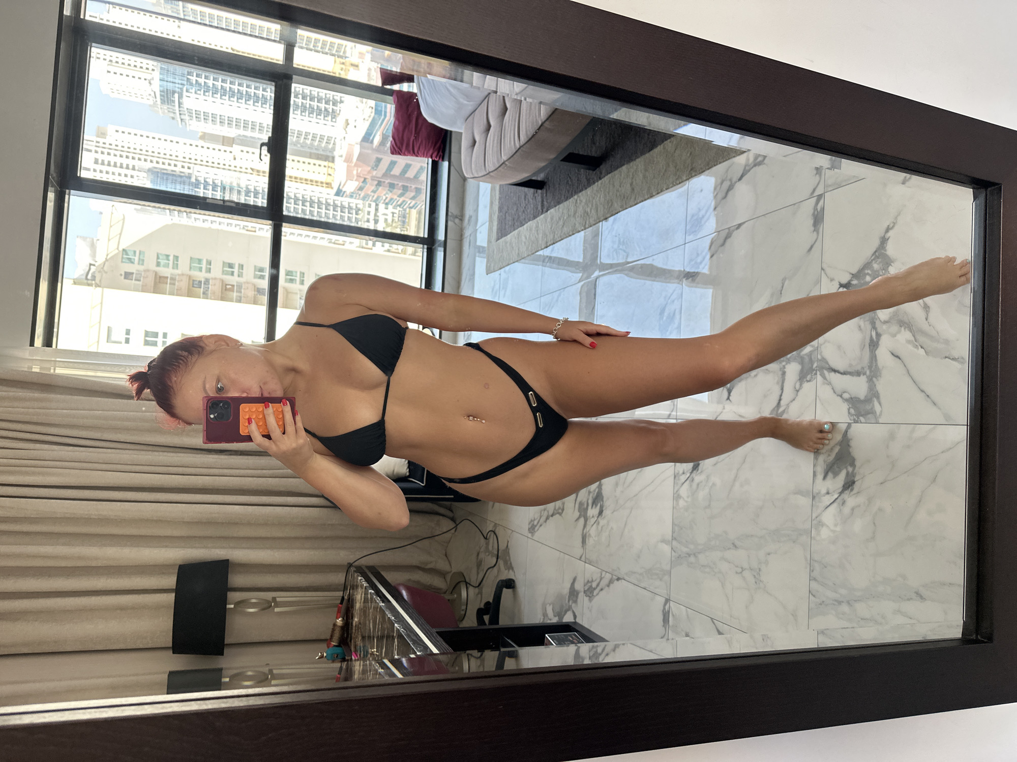 Mirror selfies in a Dubai hotel room with skyline views
