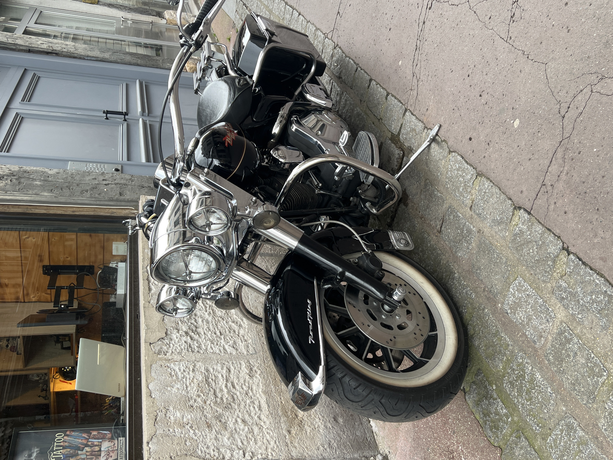 Historic Rouen buildings with teddy bears, parked motorcycle documented