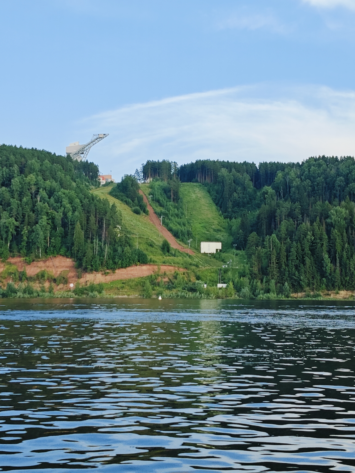 Ski jump tower overlooking a calm river in rural Russia