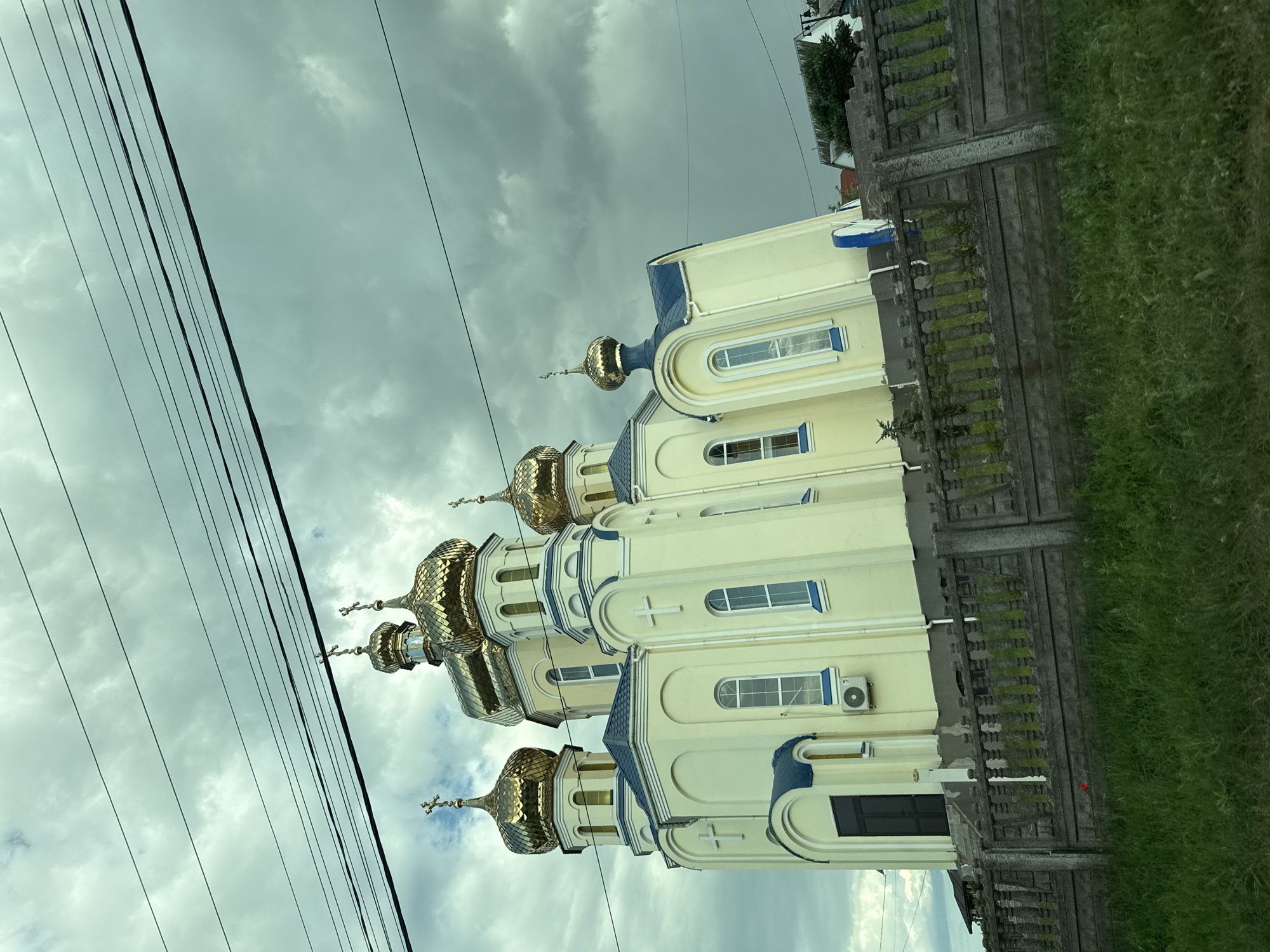 Golden-domed Orthodox church with blue trim in rural Ukraine
