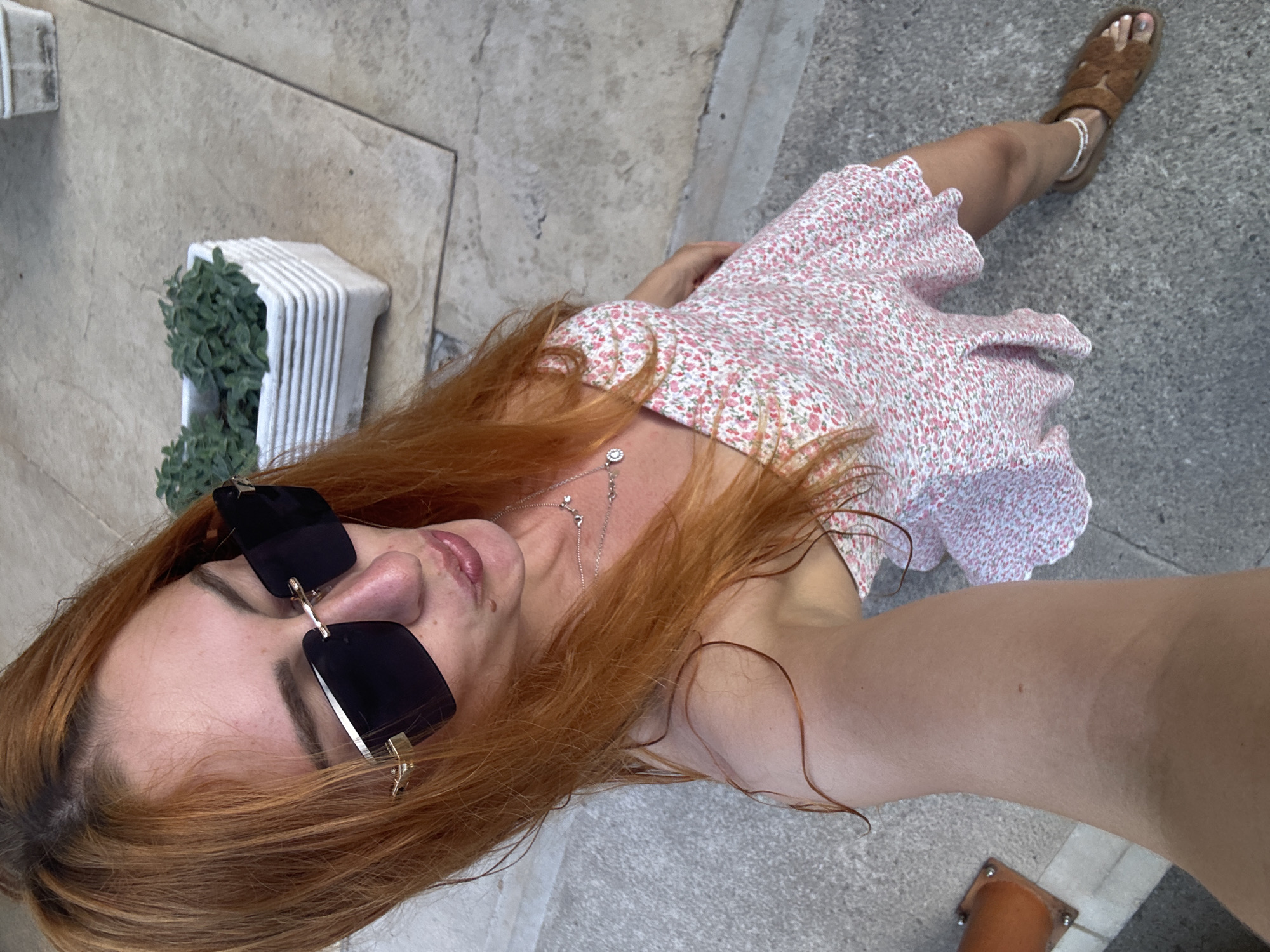 Woman takes selfies while strolling through Budva, Montenegro