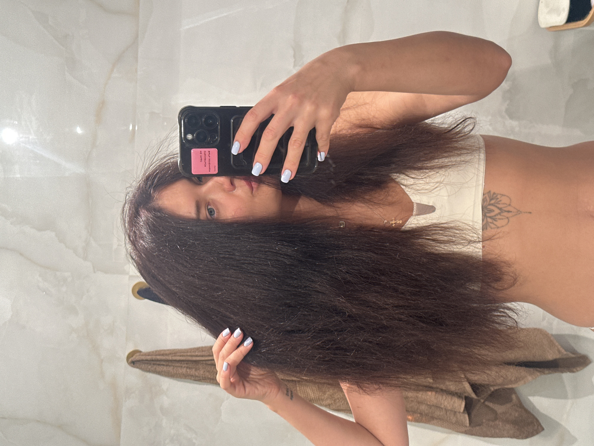 Woman takes mirror selfie in Moscow indoor setting