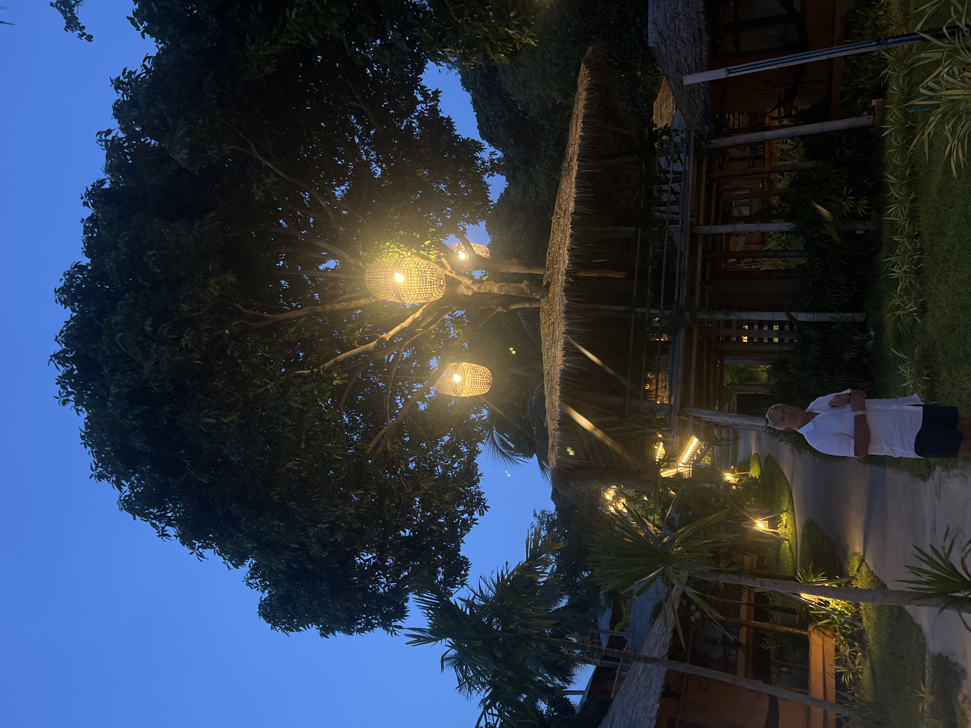 Evening lantern displays illuminate tropical beach in Thai village