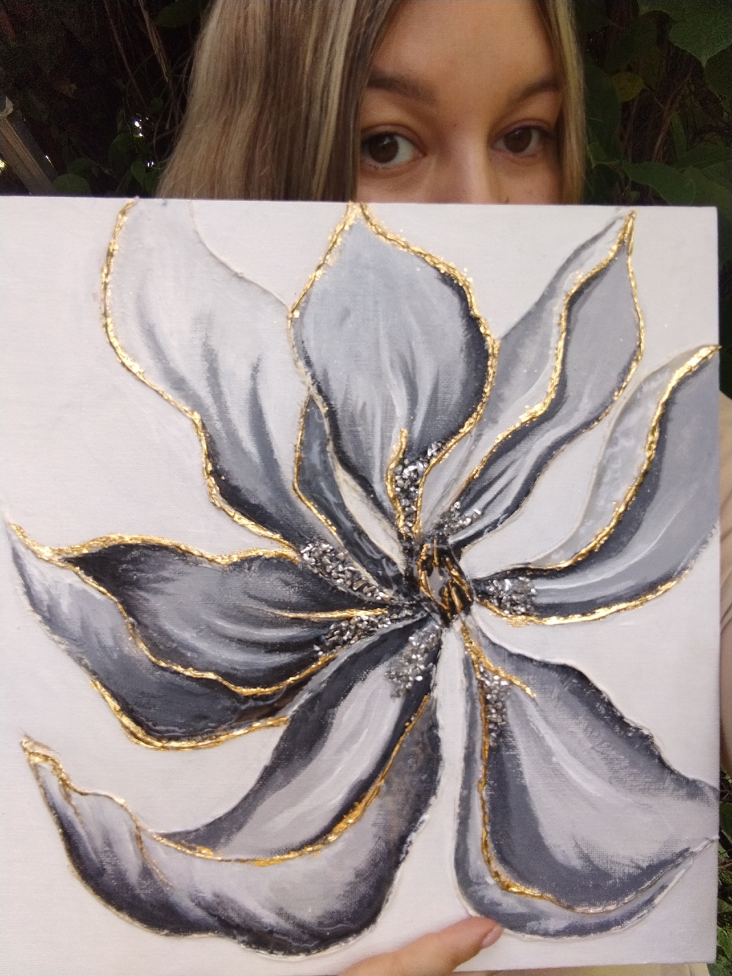 Gray and gold flower painting shown up close