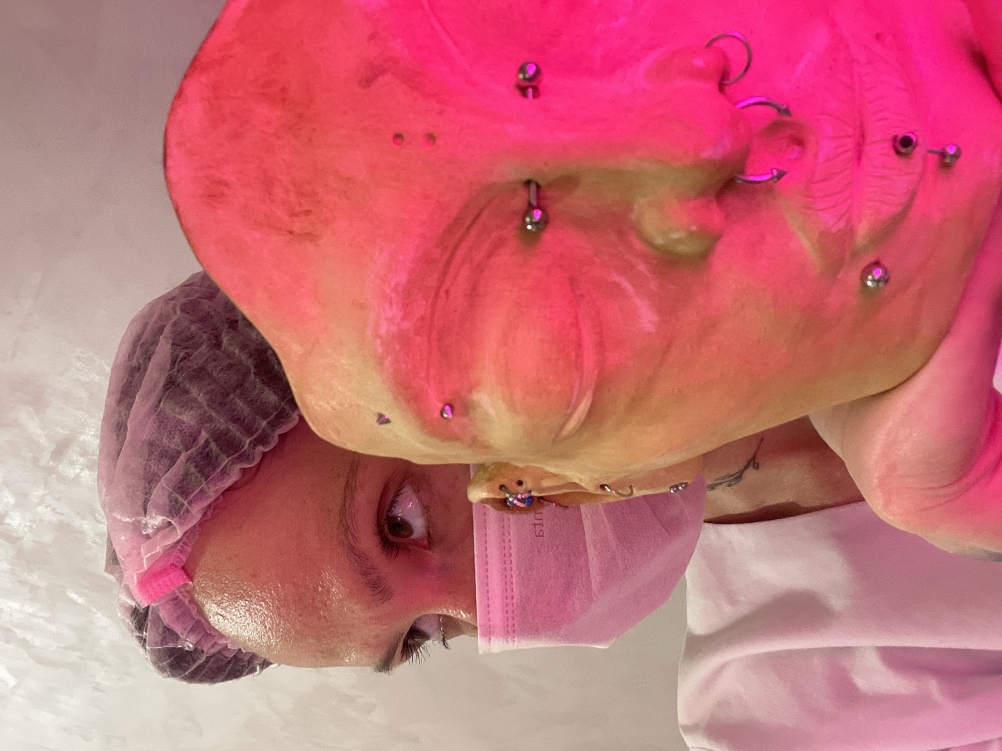 Healthcare worker takes selfies in pink protective gear